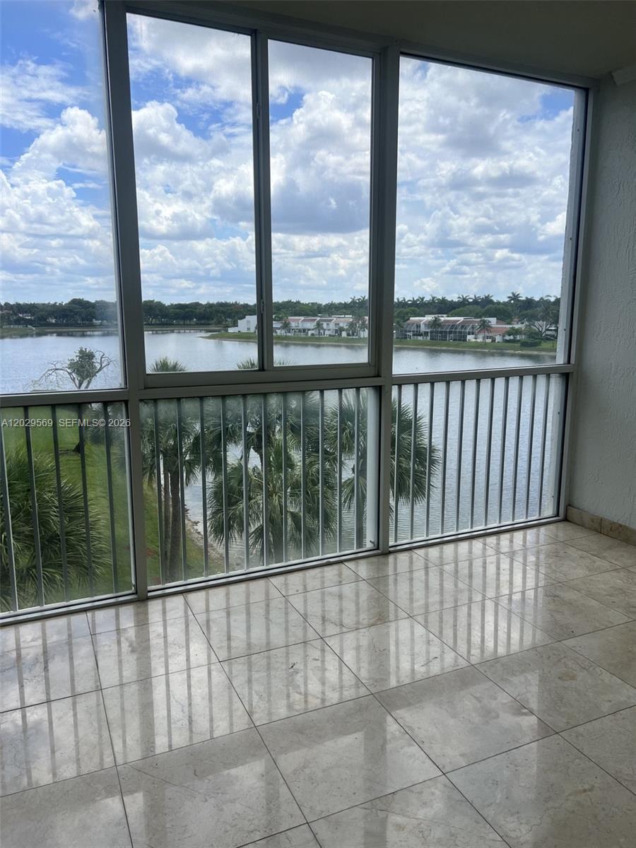 Stunning corner-unit residence located in the highly sought-after gated community of Doral Isles. This spacious 3-bedroom, 2-bath home features an open and bright floor plan with abundant natural light, breathtaking lake views, and spectacular sunset exposure. Enjoy additional living space with an enclosed balcony and a screened front porch, perfect for relaxing or entertaining. The oversized primary suite offers a walk-in closet, dual vanities, and a Roman tub. Additional features include a separate laundry room, assigned parking, and generous living areas throughout. Residents enjoy access to Doral Isles’ world-class resort-style amenities, including multiple pools, a fitness center, tennis courts, soccer and baseball fields, beach volleyball, and jogging trails. A+ Schools.