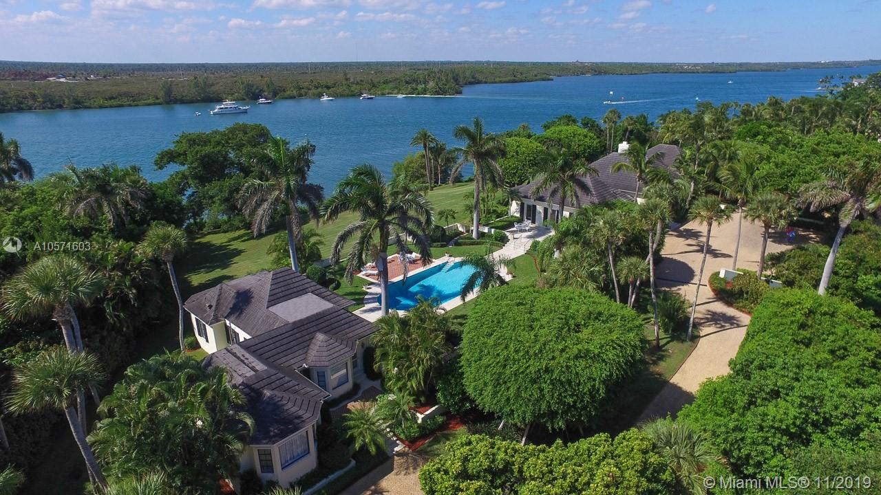 Rarely does a property become available in all of south Florida that can compare to 430 S Beach on Jupiter Island. Designed by pre-eminent architect, Marion Sims Wyeth, the 4 bedroom main house and 3 bedroom guest house sit on one of the Island's highest elevations and are surrounded by expansive terraces and a glistening pool. 366' of Intracoastal frontage provide glorious unobstructed views across the water to a ''forever natural'' sanctuary. Deep water will accommodate a large yacht and unfettered access to the ocean minutes away.  Included in the property is a 10' beachfront parcel which grants the owner deeded right to ocean access. Lush landscaping and old growth trees create complete privacy and seclusion.