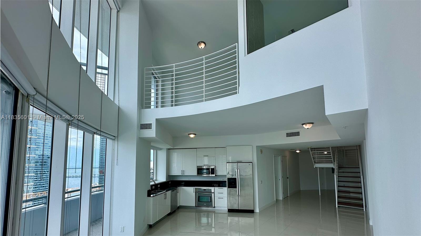 Spacious 2-bedroom + loft, 3 full bath at The Infinity at Brickell with 1,472 sq ft. Soaring double-height ceilings and floor-to-ceiling glass windows fill the open layout with natural light and offer stunning bay and city views. Upstairs features the primary suite plus a bright loft with a walk-in closet and full bathroom, perfect as a sleeping area or home office. The main floor includes an additional bedroom with closet and a full bath. Two balconies extend the living space outdoors. Enjoy marble floors, modern finishes, and resort-style amenities including pool, Jacuzzi, gym, valet, and 24-hour security. Easy to show!