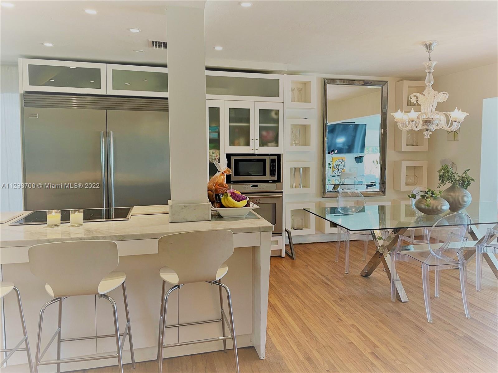 Charming 3/3 on one of KB's best streets. The spacious, open kitchen, dining and living area is filled with light and a fireplace. Other features include impact windows throughout the house, wood floors, plantation shutters, stainless steel appliances. The fenced yard has a hot tub, shed and room for a pool. One car garage can be used as an extra room. Great porch area for enjoying the afternoons. Sellers have an appraisal that shows the house square footage is approximately 1903. Reed construction so higher elevation than Mackle.