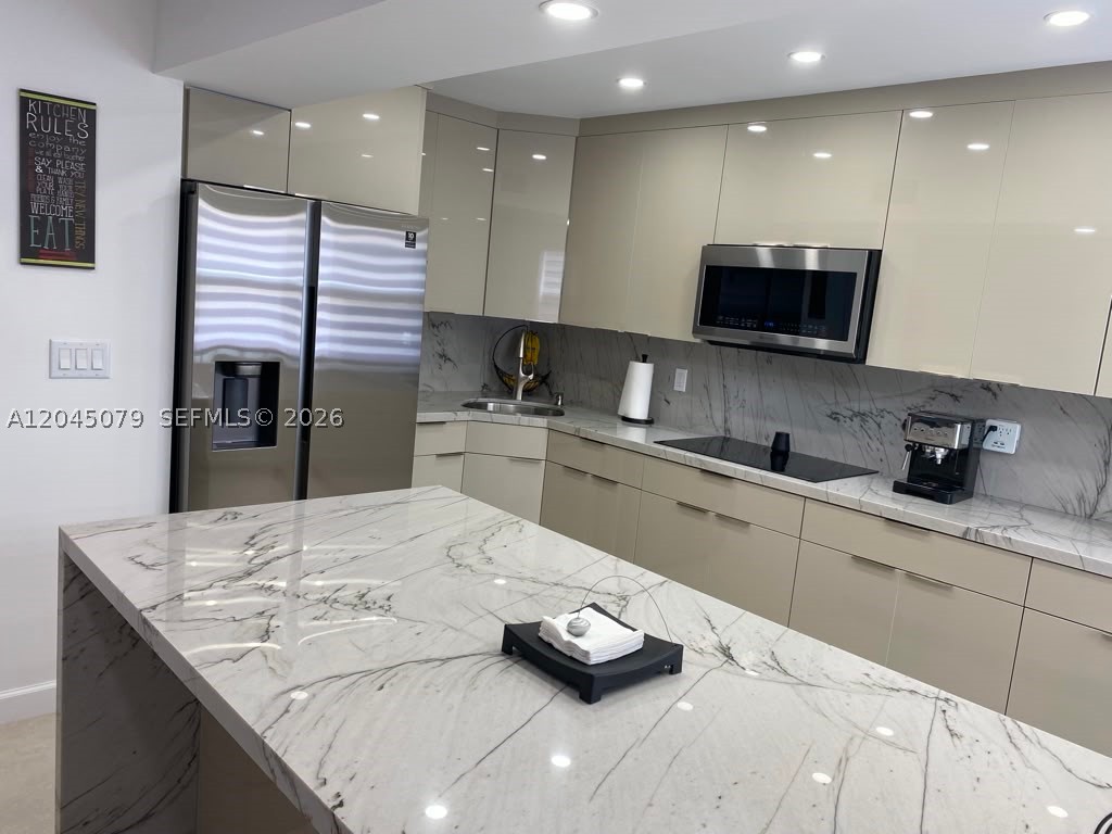 **Beautifully renovated 2-bedroom, 1.5-bath townhouse-style condo in the heart of Hialeah!** Available *August 1, 2026.* This bright and spacious home features an open-concept living and dining area with large-format tile flooring throughout, recessed LED lighting, modern ceiling fans, and abundant natural light.

The stylish kitchen offers sleek European-style cabinetry, stainless steel appliances, gorgeous quartzite countertops, and a waterfall island perfect for cooking and entertaining. The updated bathrooms feature contemporary finishes, elegant tile work, and a glass-enclosed shower.

Additional highlights include impact-resistant windows, a private balcony with a roll-down shutter for added privacy and weather protection, an in-unit washer and dryer, and two parking spaces (one assigned and one private).

Water, trash, and exterior maintenance are included through the HOA.

Ideally located near shopping centers, restaurants, schools, parks, major highways, and public transportation, providing convenient access throughout Miami-Dade County.

**Lease Terms:** Available August 1, 2026. HOA approval required prior to occupancy. HOA application fee applies to all occupants 18 years and older (legally married couples submit one application). Maximum occupancy: 4 persons. No pets. No smoking or vaping. Renters insurance required. Move-in requires first month's rent and one security deposit. Showings by appointment only.