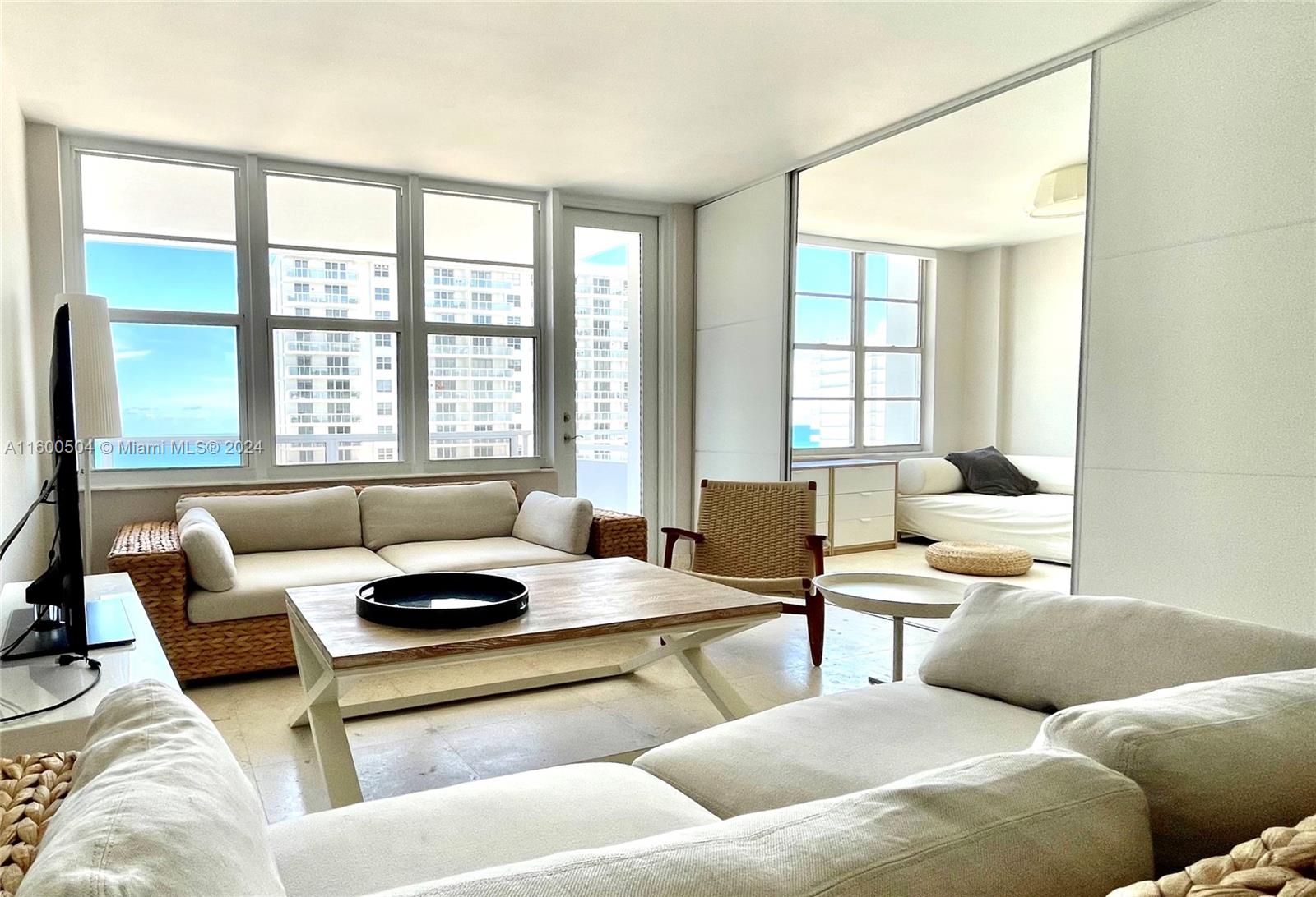 Enjoy the good life with ocean views in this renovated 2-bed/2-bath unit across the street from the beach! Stylishly furnished with ample closets, large master, beautiful floors and balcony. Second bedroom is opened to living space during the day and serves as a cozy den, which is fitted w/ a sofa that folds out to a queen bed. Sliding doors allow it to be closed as bedroom at night. Updated kitchen includes new DW and other appliances. Well maintained building w/gym, pool, business center, yoga room. Building manager on premises. Rent furnished for one year with option to renew.  Easy to show.
