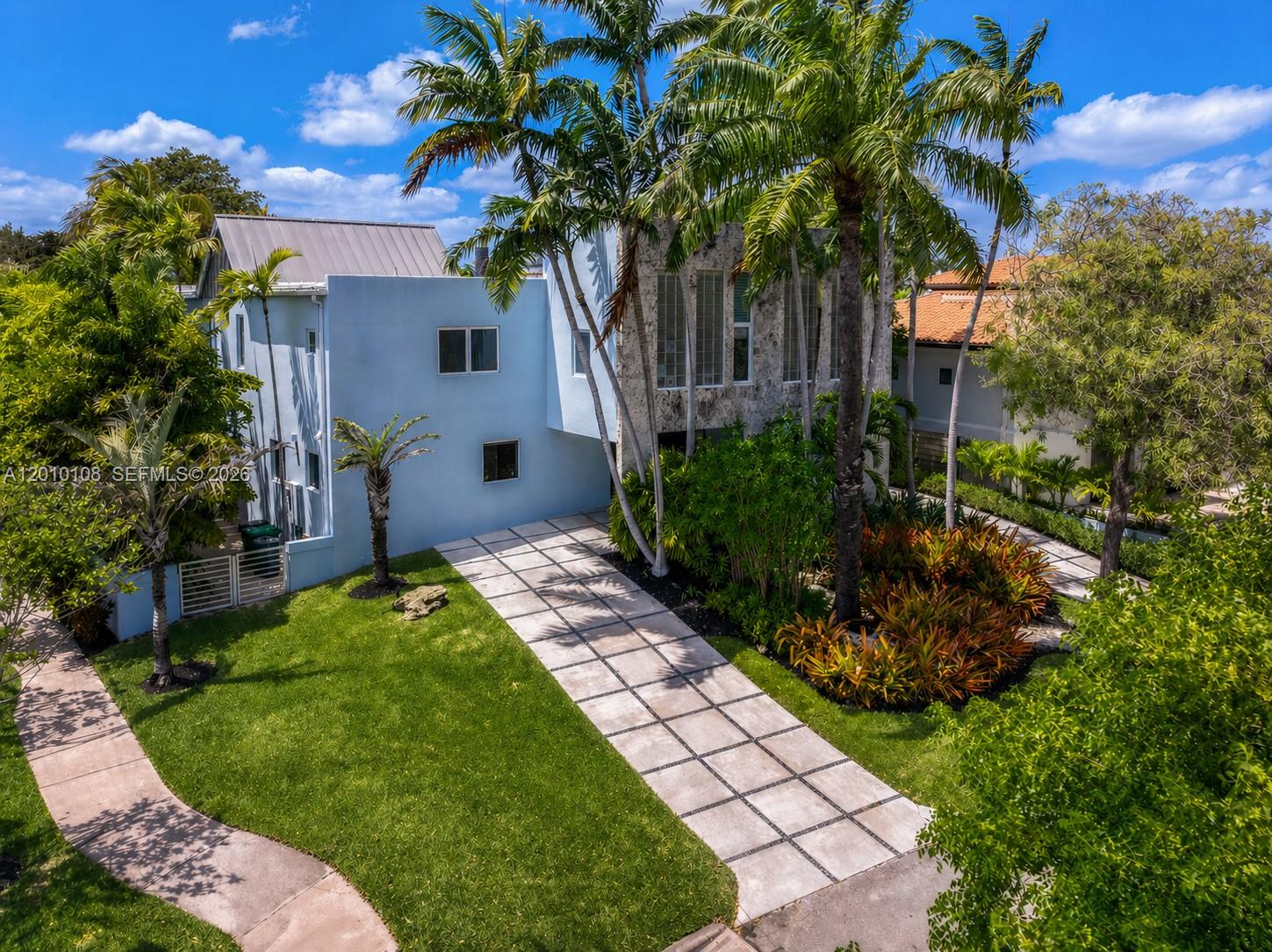 A truly exceptional Miami Modern Tropical residence set on a prime 8,010 SF corner lot, offering 3,549 SF of beautifully curated living space with 4 bedrooms and 3.5 bathrooms. Designed by architect Hervin Romney, a founding member of Arquitectonica, the home reflects a distinctive architectural vision inspired by the organic principles of Frank Lloyd Wright and the expressive forms of Antoni Gaudí, where art, design, and nature seamlessly converge.
 
This residence captivates with its abundance of natural light, soaring high ceilings, fluid open spaces, and harmonious lines that create a sense of warmth, sophistication, and effortless flow throughout the main living areas. 
 
The beautifully remodeled kitchen and bar are a true centerpiece, featuring high-end appliances, premium finishes, refined craftsmanship, and a design that balances functionality with striking aesthetics.
 
Step outside into your own private tropical retreat, where lush landscaping, graceful curved terraces, and a stunning swimming pool create an atmosphere of tranquility and escape. This outdoor sanctuary is perfect for both relaxation and entertaining.
 
As an added privilege, the property includes membership to the Key Biscayne Beach Club, offering exclusive access to one of Miami’s most coveted coastal lifestyles. Key Biscayne is renowned for its pristine beaches, charming restaurants, and vibrant yet relaxed atmosphere—delivering a true island lifestyle just minutes from the city.