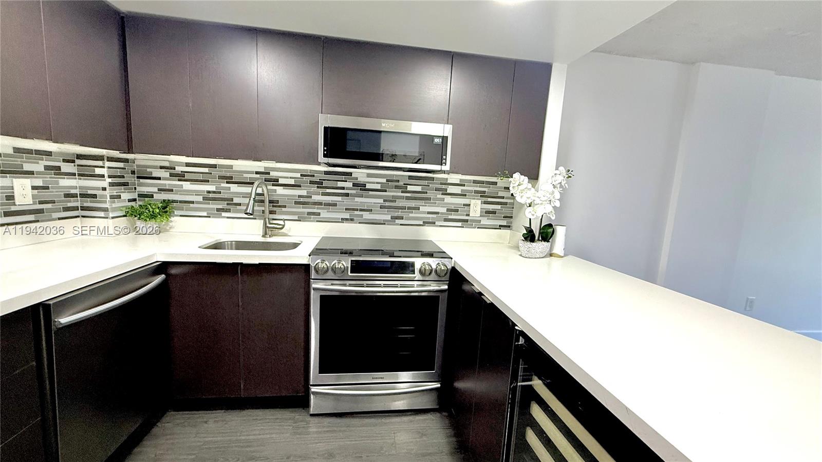 Beautiful one-bedroom unit in the Woodside community of North Miami Beach. Features a modern kitchen with stainless steel appliances, a wine cooler, new cabinetry, and quartz countertops. Impact windows and a sliding balcony door. NEW vinyl flooring throughout and LED lighting. Remodeled bathroom with a contemporary shower. Spacious bedroom with a walk-in closet. Gated community with pool, one assigned parking space, and guest parking. Excellent location near parks, tennis courts, Oleta River State Park, Greynolds Park, and easy access to SR 826.