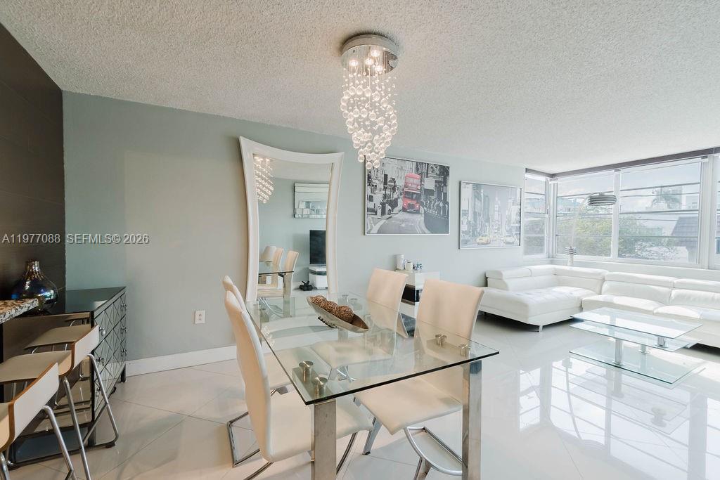Live just two blocks from the beach in this beautifully updated North Beach Miami Beach condo, located in one of the most exciting and up-and-coming areas of Miami Beach. This move-in-ready residence offers the perfect blend of coastal lifestyle, investment potential, and modern upgrades.  Inside, you’ll find sleek porcelain floors throughout, creating a clean, contemporary feel that complements the light-filled space. The unit features impact windows, providing storm protection, energy efficiency, and added peace of mind. Sold fully furnished, this condo is ideal as a primary residence, vacation home, or income-producing investment property in Miami Beach.  Enjoy the ultimate walkable lifestyle — close to the Atlantic Ocean, sandy beaches, beachfront walking paths, and North Beach Oceanside Park. The nearby park hosts community events, outdoor activities, and features lighting that allows you to enjoy the space comfortably at all times of day. Restaurants, cafés, shops, and local markets are all within easy reach. The building offers low monthly HOA dues, completed its 60-year recertification in 2026, and currently has no pending special assessments—providing added peace of mind for buyers. If you’re searching for a condo walking distance to the beach in Miami Beach, a furnished North Beach condo with impact windows, or an affordable opportunity in a rapidly growing neighborhood, this is one to see.
