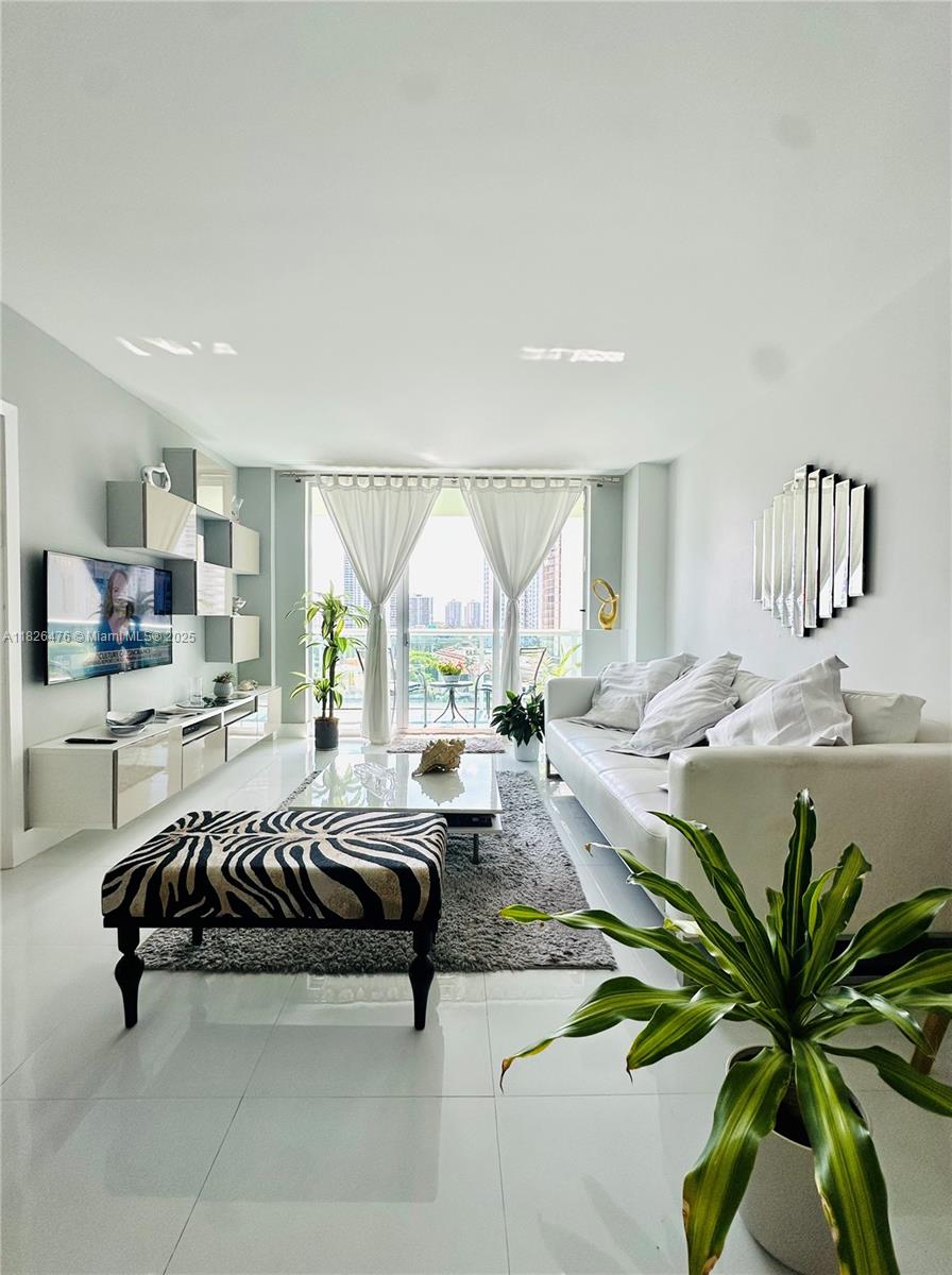 Motivated seller. Completely renovated bright and spacious residence with an unobstructed intracoastal and city view across the street from the Atlantic Ocean. Unit has been completely remodeled into a 2 bedroom with plenty of closet space. Apartment features brand new open kitchen, new bathroom, rectified white porcelain flooring throughout, built-in walk-in closets, cooking island with quartz countertop, Italian kitchen cabinetry and Washer/Dryer inside. Apartment has been tastefully decorated and is being sold fully furnished. Located in a full service building with many services and great amenities which include: 24-hr security, valet, fitness center, swimming pool, tennis, business center, BBQ area, on-site cafe, play room and more. Unit comes with one assigned covered parking.