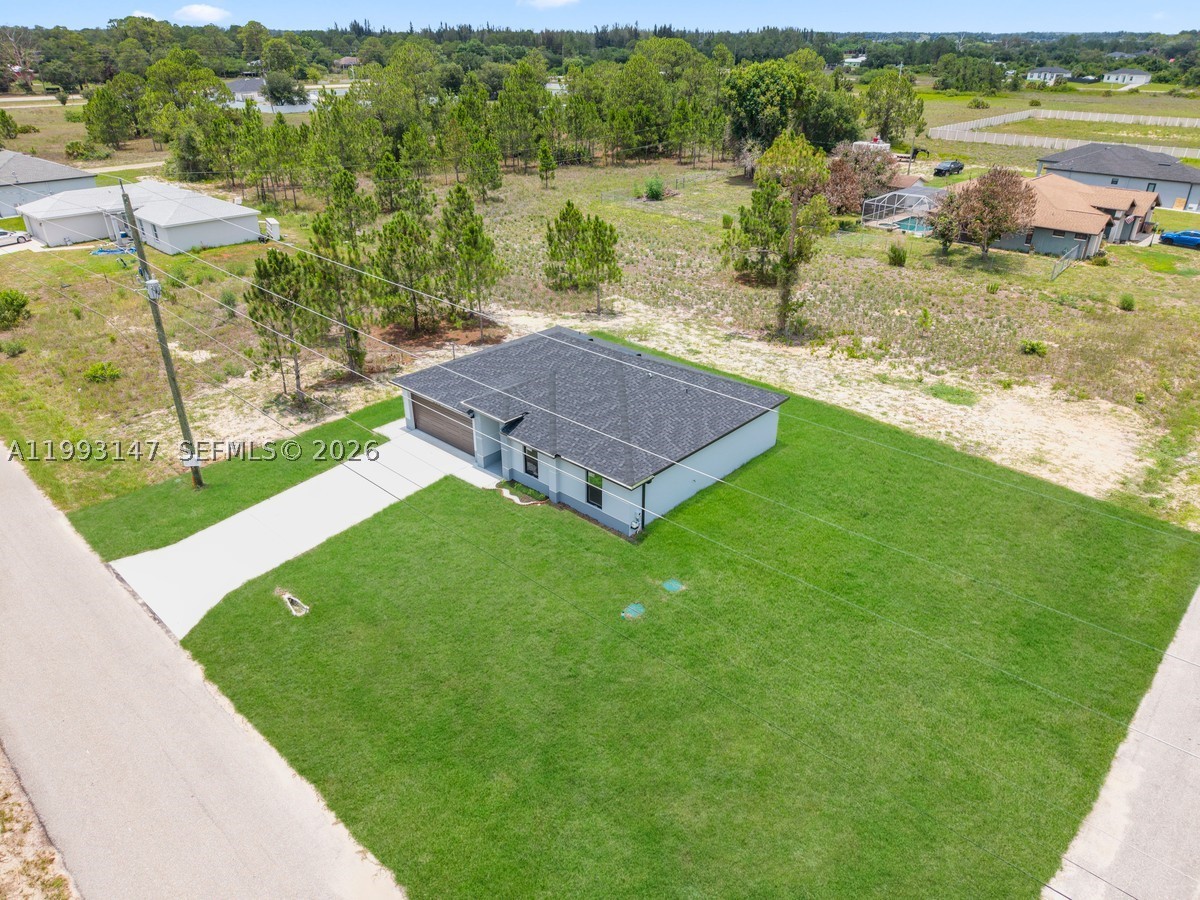 Modern 3 bedrooms, 2 bathrooms on a CORNER LOT with space for an RV or BOAT, IMPACT WINDOWS with ZEBRA BLINDS, OPEN CONCEPT kitchen with modern cabinets, QUARTZ countertops and STAINLESS STEEL kitchen appliances included. This home has an open floor plan, PORCELAIN TILES floors throughout the entire home and EPOXY GARAGE Floor. NOT IN A FLOOD ZONE. Very easy to show. Some pictures are virtually staged or from a sister house model. Don't miss this great opportunity!