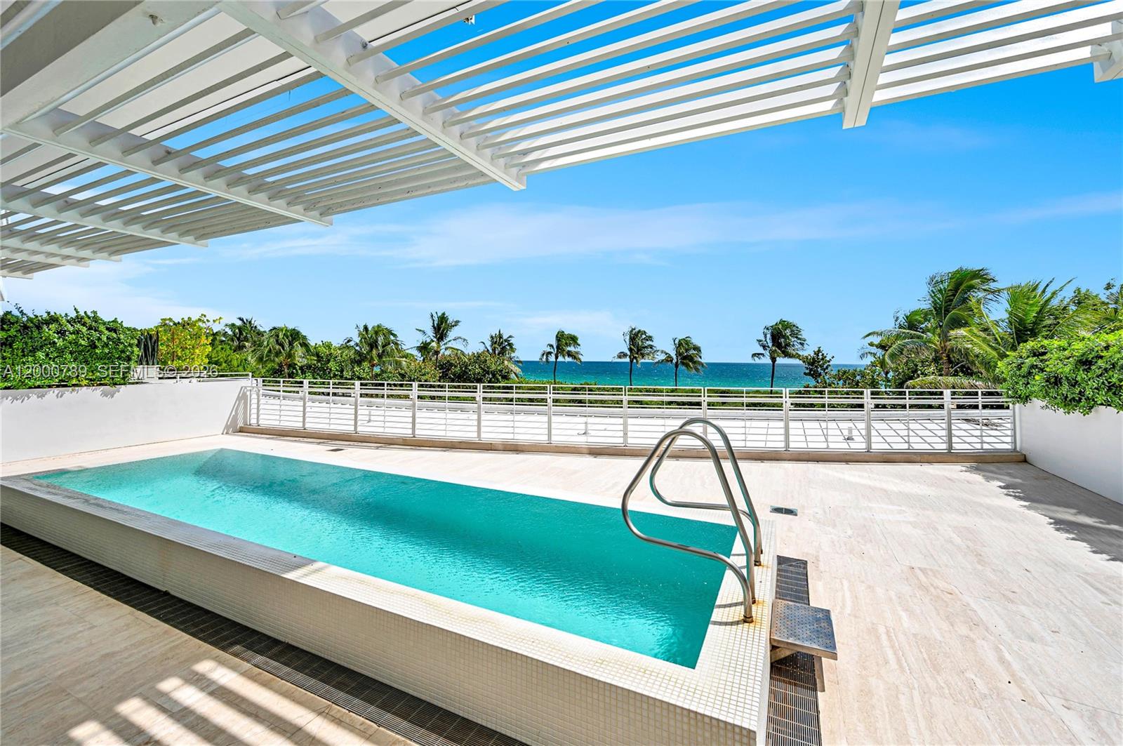 Experience the LEGENDARY FOUR SEASONS LIFESTYLE from this one-of-a-kind OCEANFRONT CORNER RESIDENCE at The Surf Club. Designed by Pritzker Prize-winning architect Richard Meier, this extraordinary corner home features 5 bedrooms, 6.5 baths, family/media room, and expansive living spaces with custom stone details throughout. Highlight with a spectacular 2,000 SF oceanfront terrace with private pool, perfect for seamless indoor-outdoor entertaining. A Boffi-designed kitchen with quartz countertops and top-tier appliances anchors the open living and dining areas. Smart home automation with Lutron lighting, integrated sound, and a 2 car temperature controlled garage. Enjoy Four Seasons’ art of hospitality—24-hr concierge, dining, housekeeping—plus 4 pools, fitness center, spa, fine dining.