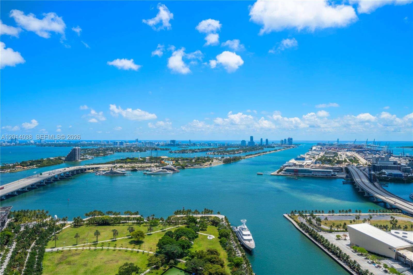 Experience the ultimate luxury in this one-of-a-kind residence at 900 Biscayne Bay. Offering an exceptional floor plan found nowhere else in the building, this home was masterfully created by combining two neighboring units. The spacious 4-bedroom, 4-bath residence spans over 2,700 interior square feet and is fully remodeled with bespoke wood millwork and thoughtfully designed custom cabinetry. Four-foot by four-foot Italian porcelain tile floors run seamlessly through the home, complemented by luxury lighting fixtures that enhance the modern ambiance. The chef's kitchen is fully equipped with premium Sub-Zero refrigeration, a Miele stovetop, and elegant marble countertops. All bathrooms have been completely updated, with both primary baths showcasing marble tile, rainfall showerheads, and spa-inspired finishes. Three separate balconies provide spectacular sunrise and sunset views, offering sweeping panoramas of Biscayne Bay, Downtown Miami, the Port of Miami, and Miami Beach. Additional highlights include a private elevator entrance, a separate service entrance, and two assigned parking spaces. Residents enjoy an unmatched lifestyle with access to world-class amenities, including a state-of-the-art gym, sauna, steam room, jacuzzi, cold plunge, resort-style pool, screening room, and valet service.