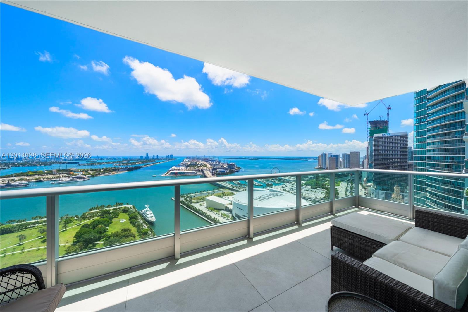 Experience the ultimate luxury in this one-of-a-kind residence at 900 Biscayne Bay. Offering an exceptional floor plan found nowhere else in the building, this home was masterfully created by combining two neighboring units. The spacious 4-bedroom, 4-bath residence spans over 2,700 interior square feet and is fully remodeled with bespoke wood millwork and thoughtfully designed custom cabinetry. Four-foot by four-foot Italian porcelain tile floors run seamlessly through the home, complemented by luxury lighting fixtures that enhance the modern ambiance. The chef's kitchen is fully equipped with premium Sub-Zero refrigeration, a Miele stovetop, and elegant marble countertops. All bathrooms have been completely updated, with both primary baths showcasing marble tile, rainfall showerheads, and spa-inspired finishes. Three separate balconies provide spectacular sunrise and sunset views, offering sweeping panoramas of Biscayne Bay, Downtown Miami, the Port of Miami, and Miami Beach. Additional highlights include a private elevator entrance, a separate service entrance, and two assigned parking spaces. Residents enjoy an unmatched lifestyle with access to world-class amenities, including a state-of-the-art gym, sauna, steam room, jacuzzi, cold plunge, resort-style pool, screening room, and valet service.