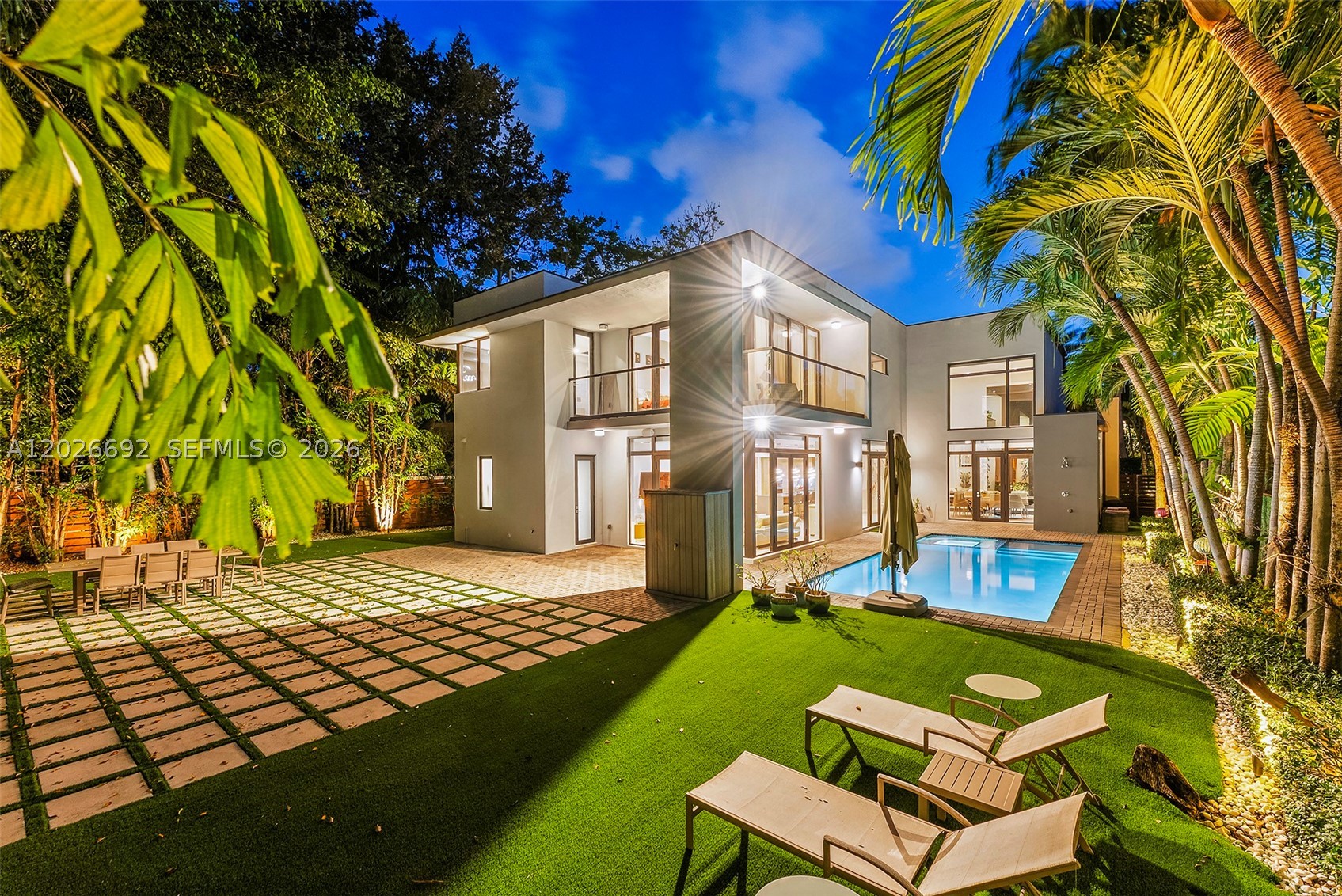 Discover the pinnacle of luxury in this extraordinary smart home nestled in one of South Miami’s most coveted enclaves. Designed with comfort, privacy and effortless sophistication in mind, the residence features a full  automation system controlling lighting, climate, motorized shades, and premium surround sound throughout the main living areas. The open concept layout includes a gas fireplace, built-in bar, library nook and an elegant Brazilian wood-accented wall. The gourmet kitchen is appointed with Italian Mia Cucina cabinetry, Wolf and SubZero appliances, gas range, and a spacious walk-in pantry. Upstairs a former guest bedroom has been transformed into a striking home theatre with a 110” screen, while its former bathroom has been reimagined as a retro-inspired kitchenette. The adjacent guest bedroom has been converted into a playful game room enhancing the home's entertainment appeal. The luxurious primary suite offers a private balcony, spa-style bath with oversized dual shower, and a generous custom closet. Step outside to a year round entertaining retreat featuring a sparking pool, artificial turf lawn, and outdoor shower. Additional highlights include a two car air conditioned garage, EV charger, and abundant storage. This home is truly turnkey and designed for elevated modern living.