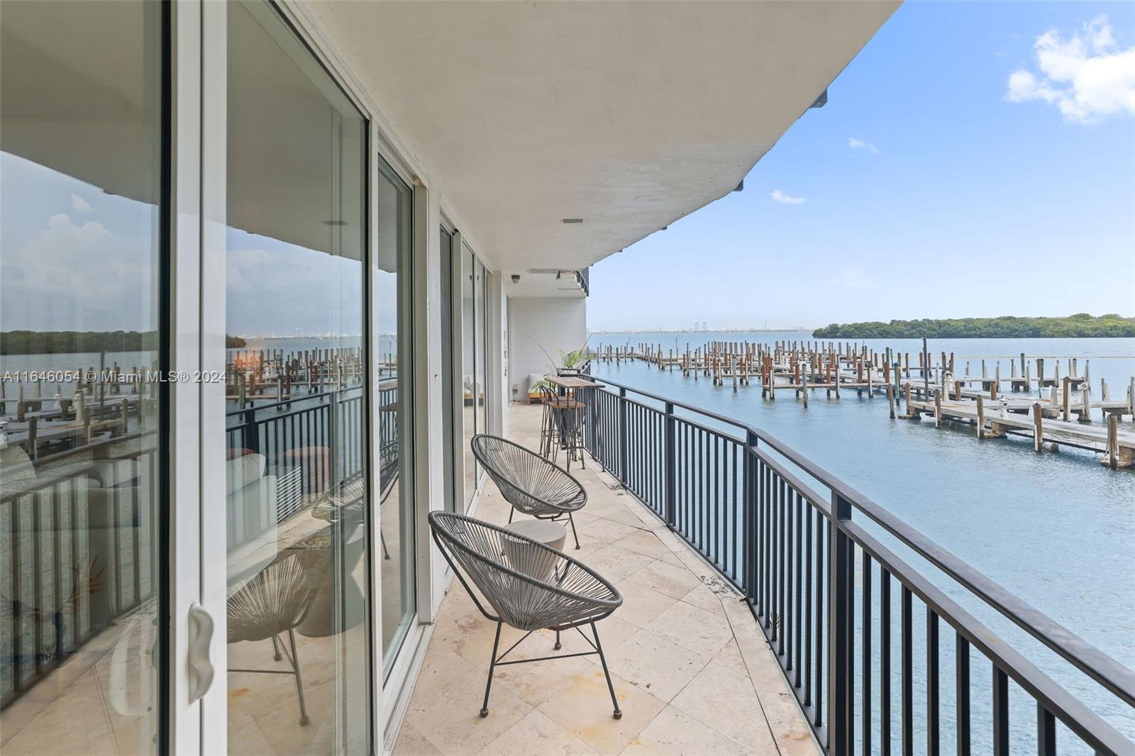 Sizable unit with lovely views of the Bay is available in the established Palm Bay Condo. The unit has travertine floors throughout, refined wallpaper details & elegant built-ins for easy styling. The huge living space sets the stage for fun-filled soirees, dinner parties, or even comfy movie nights in. The corner unit offers 2 balconies w/impact sliding doors overlooking the water and the treetops for a definite calming effect. Palm Bay is a private gated community residing directly on Biscayne Bay in Mimo, with its own private marina. Varied amenities include 24-hour security, doorman service, pool, tennis & pickleball courts & gym. 1 covered parking space & plenty of guest spots. Spend evenings perusing all the best Mimo restaurants around the corner from your home. A Very Special Home.