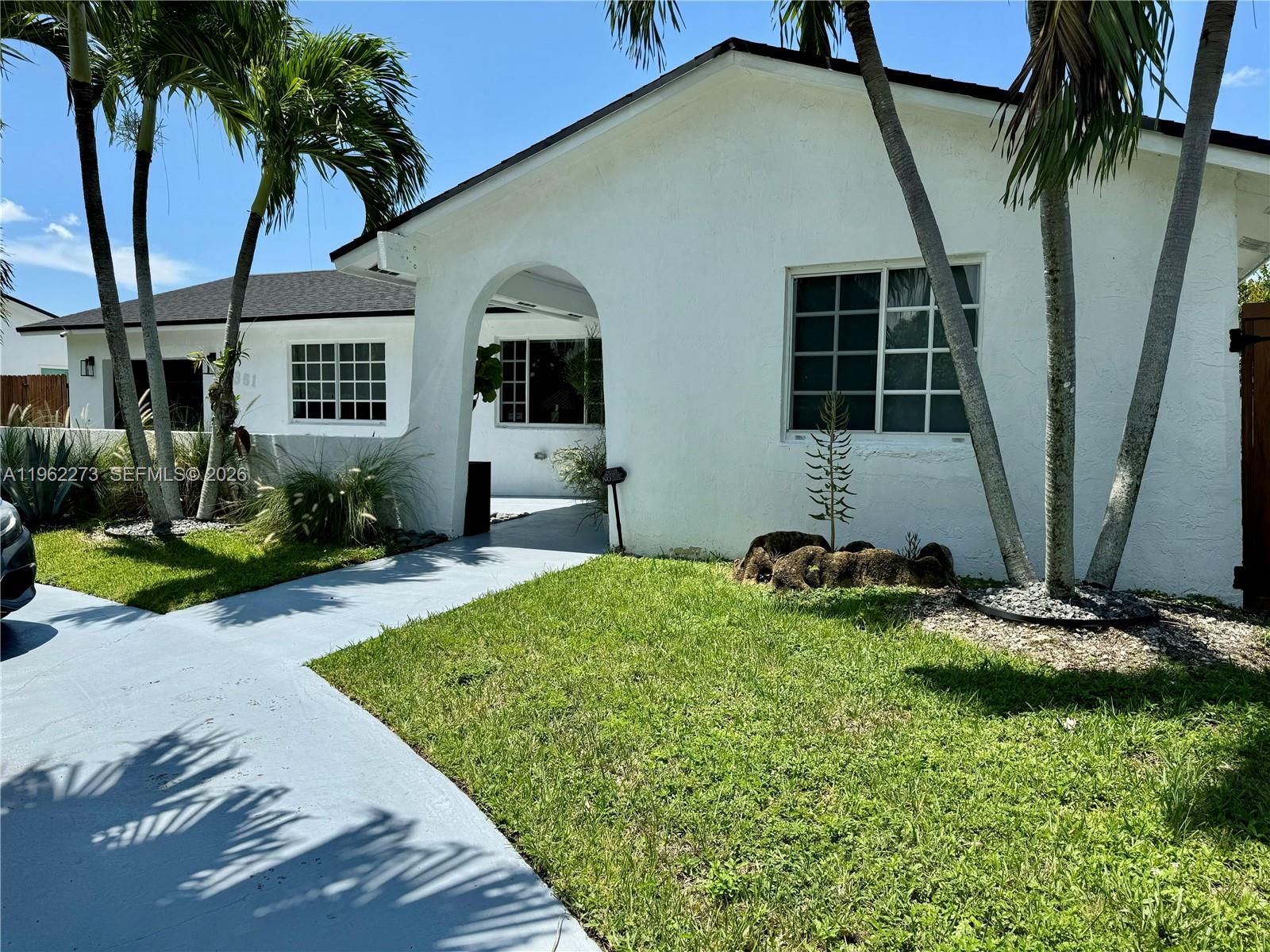 Lake Front Beauty, Enjoy evening Sunsets in this tranquil swimmable aquaforic Lake, use your Kayak or Paddle boards too. You are allowed to fish and use electric boat. Such a unique home with 4 bedrooms, 2 baths, circular driveway, gated yard, coconut trees, Tiki Hut w/Concrete floor and ceiling fans, covered patio for hosting gatherings or simply take in the peaceful scenery. SS New appliances, washer, dryer, remodeled. Live in this quiet neighborhood but at walking distance to fine dining, supermarkets. Turnpike access just mins. away. Near airport and the Fl. keys.