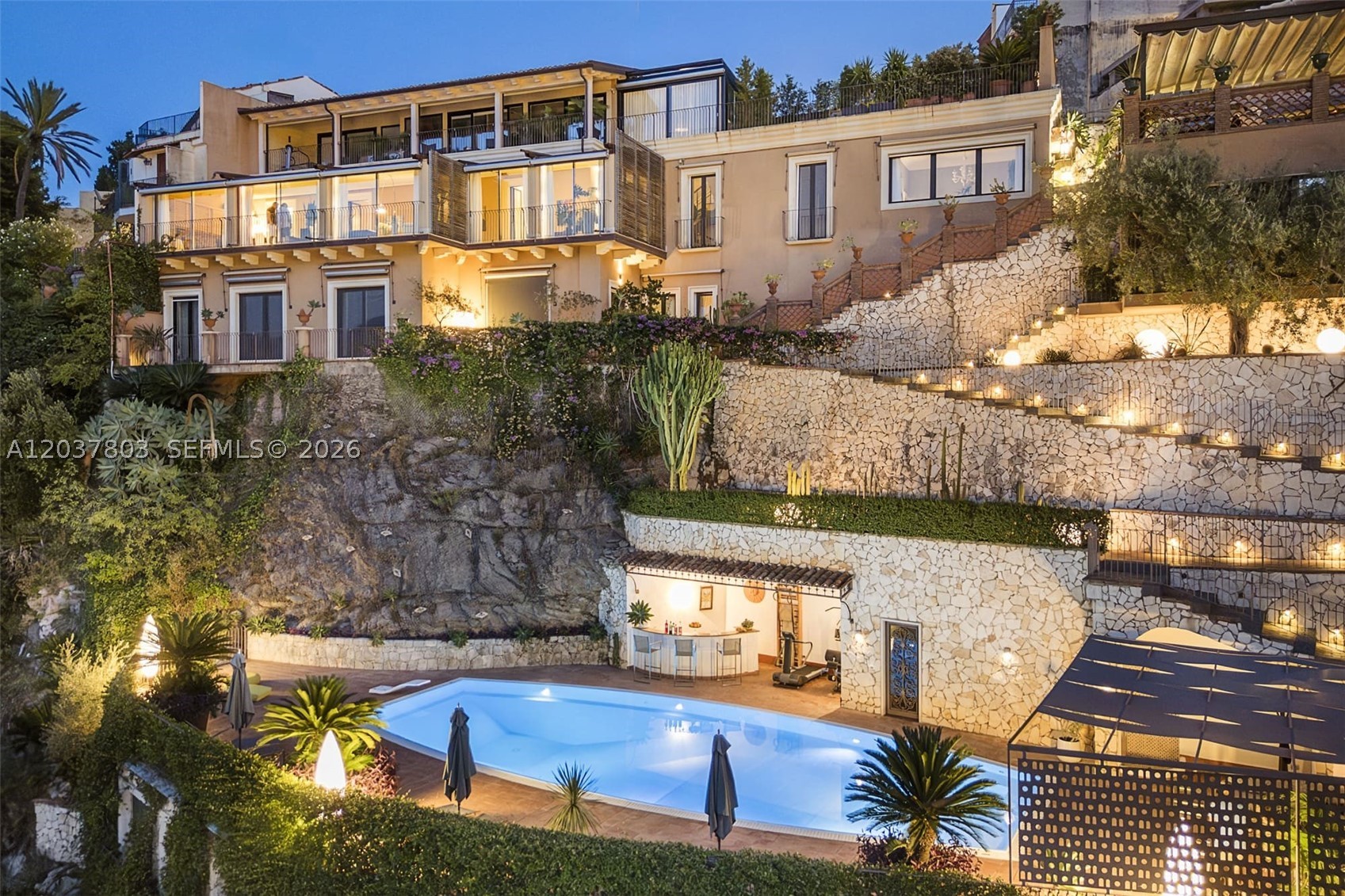 MLS Luxury Listing Presentation
Villa Luxury Taormina – Sicily, Italy
Exclusive Waterfront Estate Overlooking the Bay of Mazzarò
Nestled within one of the most breathtaking natural settings in Sicily, this extraordinary luxury villa enjoys a commanding position above the renowned Bay of Mazzarò in Taormina. Built into the cliffside and suspended above the crystal-clear Mediterranean Sea, the property combines contemporary design, timeless elegance, and authentic Sicilian craftsmanship.
Offering unparalleled privacy, direct sea access, panoramic terraces
Direct private access to the sea
Saltwater infinity pool
Multiple panoramic terraces
Independent guest accommodations
Private parking area
Fitness area and outdoor lounge
Walking distance to restaurants, boutiques, beach clubs, and cable car access to historic Taormina
Exceptional rental and hospitality potential
Ideal for guests, extended family, staff, or luxury rental operations.
Outdoor Amenities
Resort-Style Pool Area Saltwater panoramic swimming pool Sun deck Lounge area Outdoor bar Fitness area
Outdoor shower and bathroom Waterfront Lifestyle Private path to the beach Direct access to the Mediterranean Sea Spectacular sunrise and sunset views Air Conditioning Wi-Fi throughout
Taormina remains one of the most prestigious luxury destinations in the Mediterranean, attracting international buyers, celebrities, and high-net-worth travelers year-round