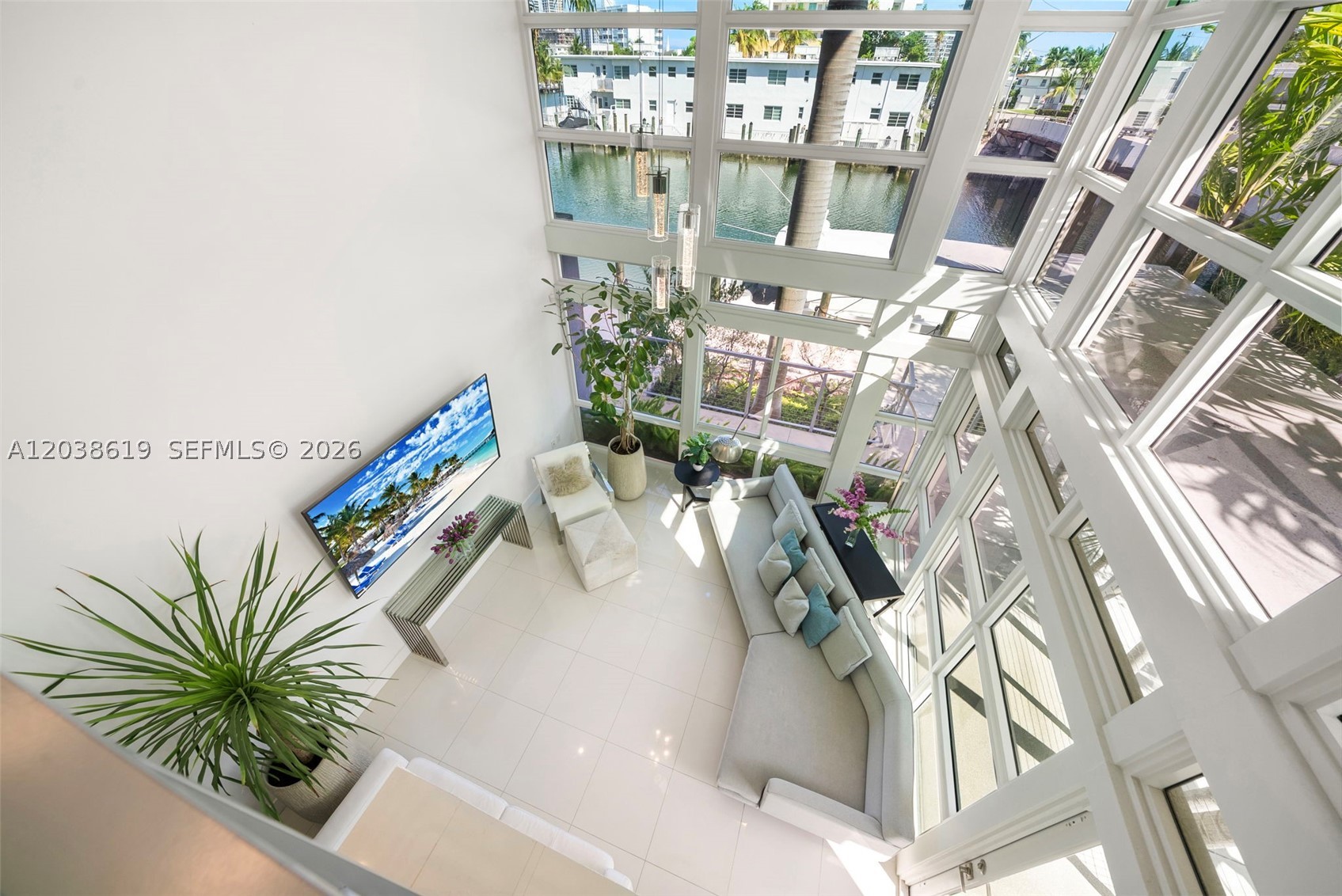 Stunning waterfront Townhouse at Iris on the Bay, a gated community in Normandy Isle in Miami Beach. Unique loft-style corner unit, 3 bedrooms and 3.5 bathrooms w/water views throughout. Built in 2019, this home is ready to move in! A total of 2,626 SF of indoor & outdoor space w/private elevator. The 18ft ceilings give the entry and living room space a WOW effect. Gourmet kitchen w/custom cabinets & pantry, Subzero and Wolf appliances. Secondary suite features 10 ft ceilings and impressive walking Closet. Primary suite opens to a private roof top terrace with incredible water views. Impact windows & doors, electric blinds, custom closets. 2 car garage with plenty of custom storage cabinetry and electric car terminal. Across from Fairway Park w/tennis & Golf. Walk to Beach & restaurants. Low HOA fees. Possibility to rent a boat slips from other owners. A true gem!