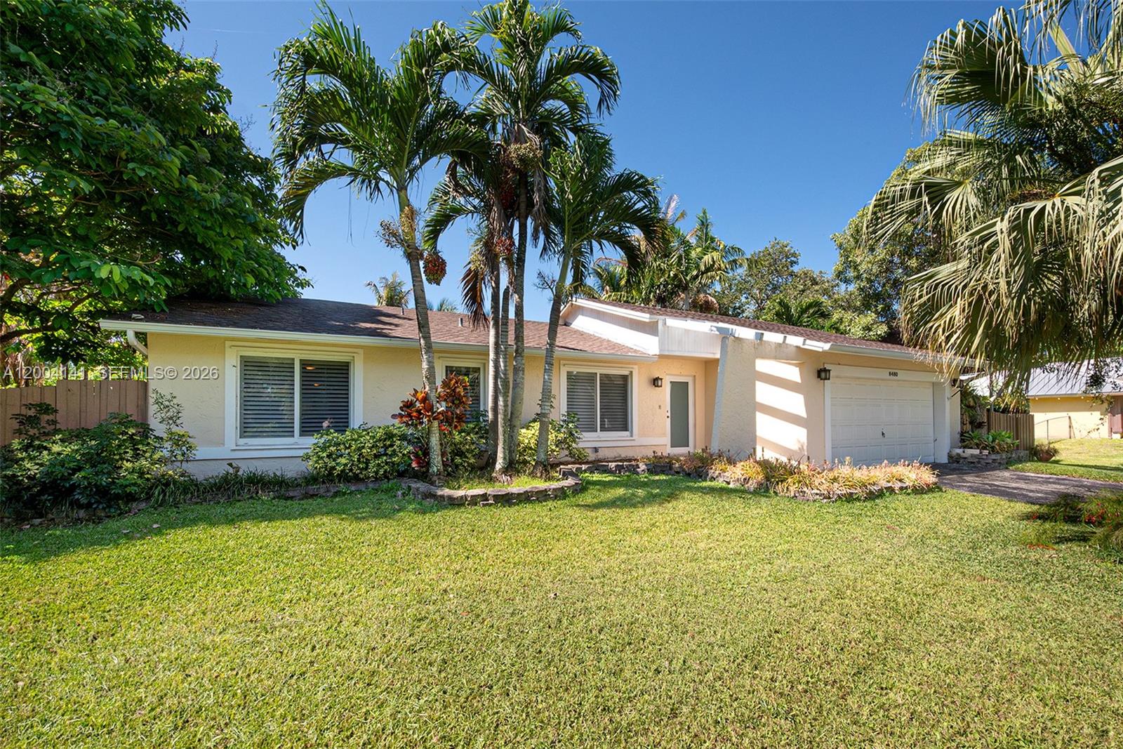 Cozy and spacious 3-bedroom, 2-bath home with high ceilings and a lot of natural light. Comes on a large 15,625 sq ft lot. Features a comfortable living and dining area, plus an open kitchen and family area with a nice sized bar all overlooking the terrace and pool areas.  Bedrooms are generously sized with good closet space. The garage is currently being used as a game room. Enjoy outdoor living with a large screened-in terrace, heated pool w/ jacuzzi and outdoor kitchen—perfect for entertaining. Features also some Bahama blinds, a new roof, new pool heater, new gutters, full-house generator, and impact windows and doors. Additional highlights include an air-conditioned shed for extra storage or workspace, sprinkler system and a new tall spacious covered canopy on the side—ideal for an RV, boat, or multiple vehicles. With a little TLC, this property has great potential to become a more beautiful home.