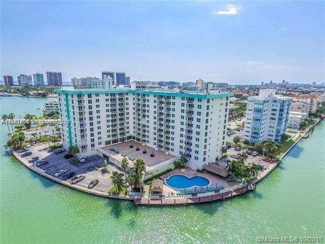 Bright and spacious unit with full Southern Exposure, in the desirable neighborhood of Bay Harbor Islands. Water views from this spacious 1 bedroom and 1 bathroom unit with 950 sq.ft of living space plus balcony. Impact windows and large kitchen. Washer & dryer hookup in unit. Gated building with 24 hrs security, clubhouse, fitness center, marina and oversized pool by the bay with bbq area. Maintenance fee includes the A/C, basic cable, internet, water as well as the common areas maintenance. Close to the beach, restaurants, shops and the A rated K-8 school. Available docks for rent in the condominium.