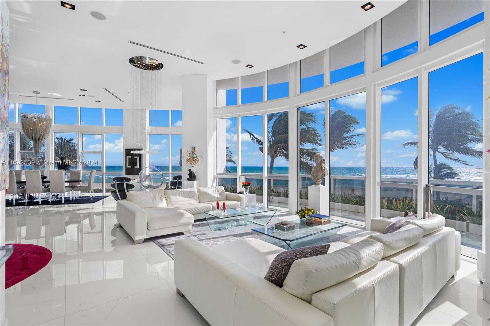 This exclusive beach villa redefines luxury with a unique feature: 45-second drive from street level directly into your private garage. Offering a seamless blend of privacy and coastal convenience, within 4,893 sqft of elegantly designed interiors and 686 sqft of private terraces. With soaring 14-foot ceilings, breathtaking ocean views, and refined living spaces, including 4 beds + den, 5.5 baths, private elevator, 2-car garage, and 3 reserved spaces. The main level features a custom entertainment bar, gourmet kitchen with SubZero and Miele appliances, and expansive primary suite with panoramic views, terrace access, and spa-like bath. The lower level includes guest suites, second kitchen, and beachside cabana, offering unmatched beachfront tranquility in Miami’s most exclusive enclave.