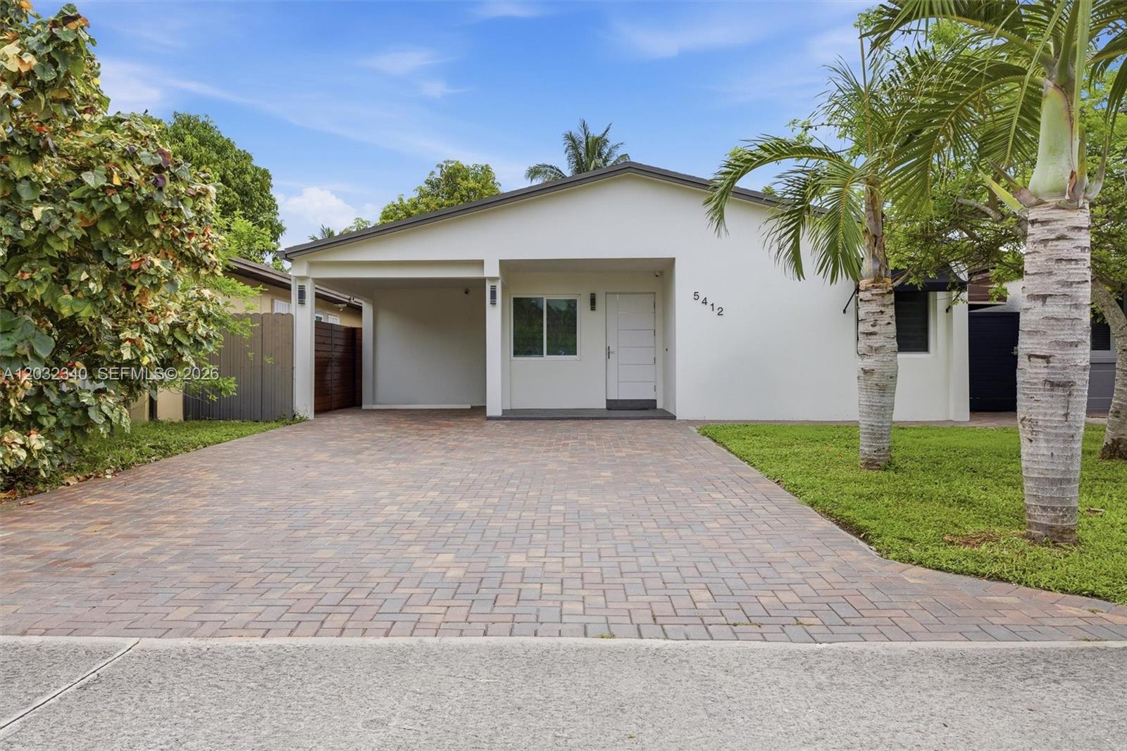 Beautifully renovated 3-bedroom, 2-bathroom home in the heart of Miami Gardens featuring a bright open-concept layout and modern finishes throughout. This move-in-ready property offers a sleek contemporary kitchen with white cabinetry, quartz countertops, stainless steel appliances, and ample storage. Spacious living areas are complemented by large-format porcelain tile flooring, while the bedrooms feature warm wood-style flooring for added comfort.
The updated bathrooms showcase modern fixtures, glass-enclosed showers, and designer finishes. Step outside to an expansive covered patio perfect for entertaining year-round, complete with ceiling fans and plenty of space for outdoor dining and gatherings. The fully fenced backyard provides privacy and security, while the oversized driveway offers ample parking.
Additional features include impact windows and doors, updated electrical and plumbing, dedicated laundry area, and beautifully maintained landscaping. Conveniently located near major highways, shopping, dining, schools, and parks.
A true turnkey opportunity—just bring your furniture and enjoy South Florida living at its best.