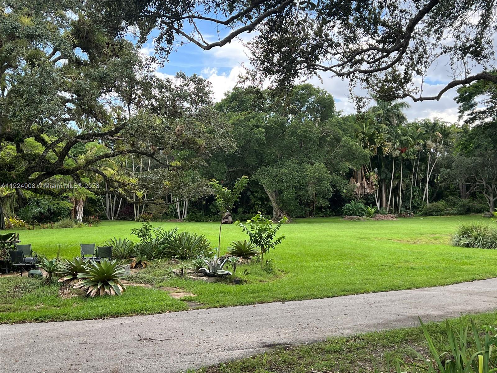 Five Acres in the heart of Pinecrest, this Tropical Oasis offers endless opportunities to renovate or custom build on one-of-a-kind grounds.Original Landscapes by Raymond Jungles, this exquisite property boasts an extensive & rare collection of exotic trees & vibrant plants throughout.Serene trails, lush gardens & hidden retreats, all overlook the breathtaking & intricately man-made lagoon.The existing resort-style home, features over 11,000 adj.SF w/large open living spaces, 5 bdrms, 8 baths & 2 half baths.A separate two-story structure includes a state-of-the-art wine cellar & entertainment area, complete w/ a tennis court & stunning grotto inspired pool detailed w/cascading natural stone. 
Plans included for an impressive 20,000 sq ft estate, designed by the distinguished Cesar Molina.