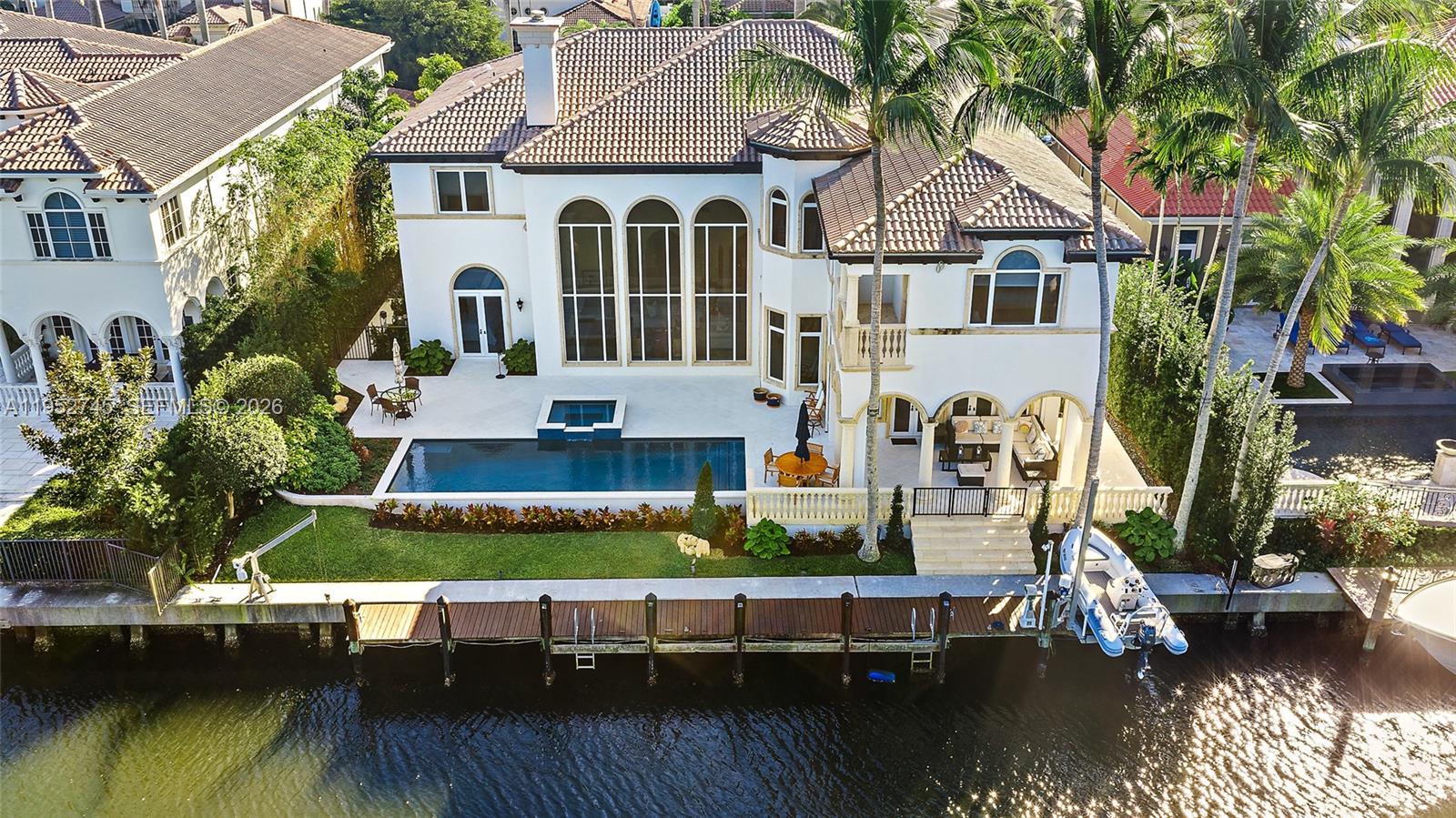 Rarely available waterfront estate priced under $1,000 per square foot! This expansive home offers 90 feet of prime waterfrontage, accommodating up to a 70-foot yacht with no fixed bridges. The backyard was completely reimagined in 2025 with a new heated salt water pool and spa, all new landscaping, hardscaping, and phantom screens. Inside, the home features six en-suite bedrooms, a private office, loft, dedicated storage rooms, and an oversized club room ideal for entertaining. One of the few homes in Harbour Isles with a true four-car garage and proper auto court. Finished with Wolf and Sub-Zero appliances, marble floors, solid wood doors, and full impact windows. Just minutes from the best shopping and dining. This is a must-see opportunity!