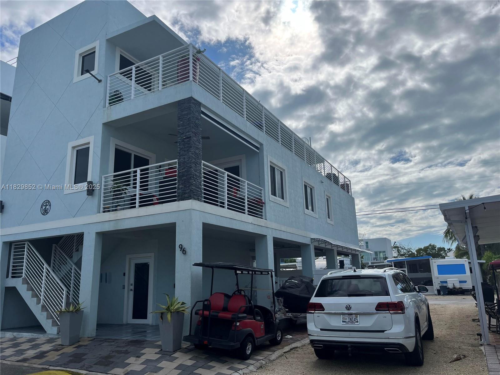 Luxurious contemporary home in Paradise. This 4 bedroom 4 1/2 bath home with private elevator. Is built like a fortress all block construction with poured concrete roof, hurricane impact windows and doors. Two balconies over looking the bay and pool. The marina is steps away. There is a roof top terrace over looking the bay to see the beautiful Key Largo sunsets.