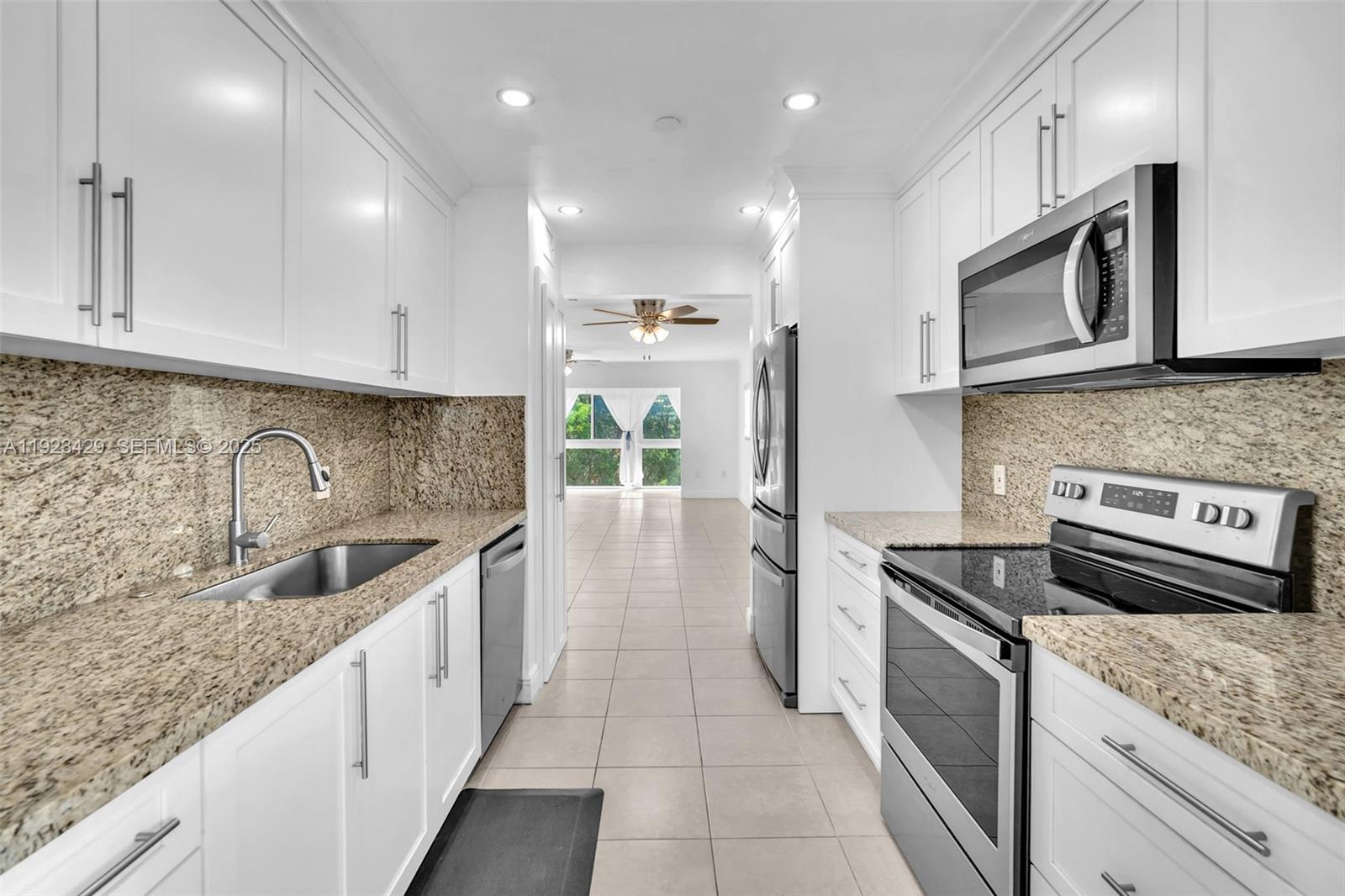 SS appliances, white cabinets, mottled brown granite counters & pantry. Cozy breakfast nook beside kitchen with serving counter & built-in wine cooler. Large master with custom closets, double sinks & glass enclosed shower with both rain & movable shower heads. Very attractive cabinetry, counters & finishes. The unit is finished with 18 x 18 tiles and horizontal blinds throughout. Bedrooms & living areas all have ceiling fans with lights. Best 55+ Community in SE Florida near to I75, restaurants, shops & services. Community has amazing array of amenities for residents.