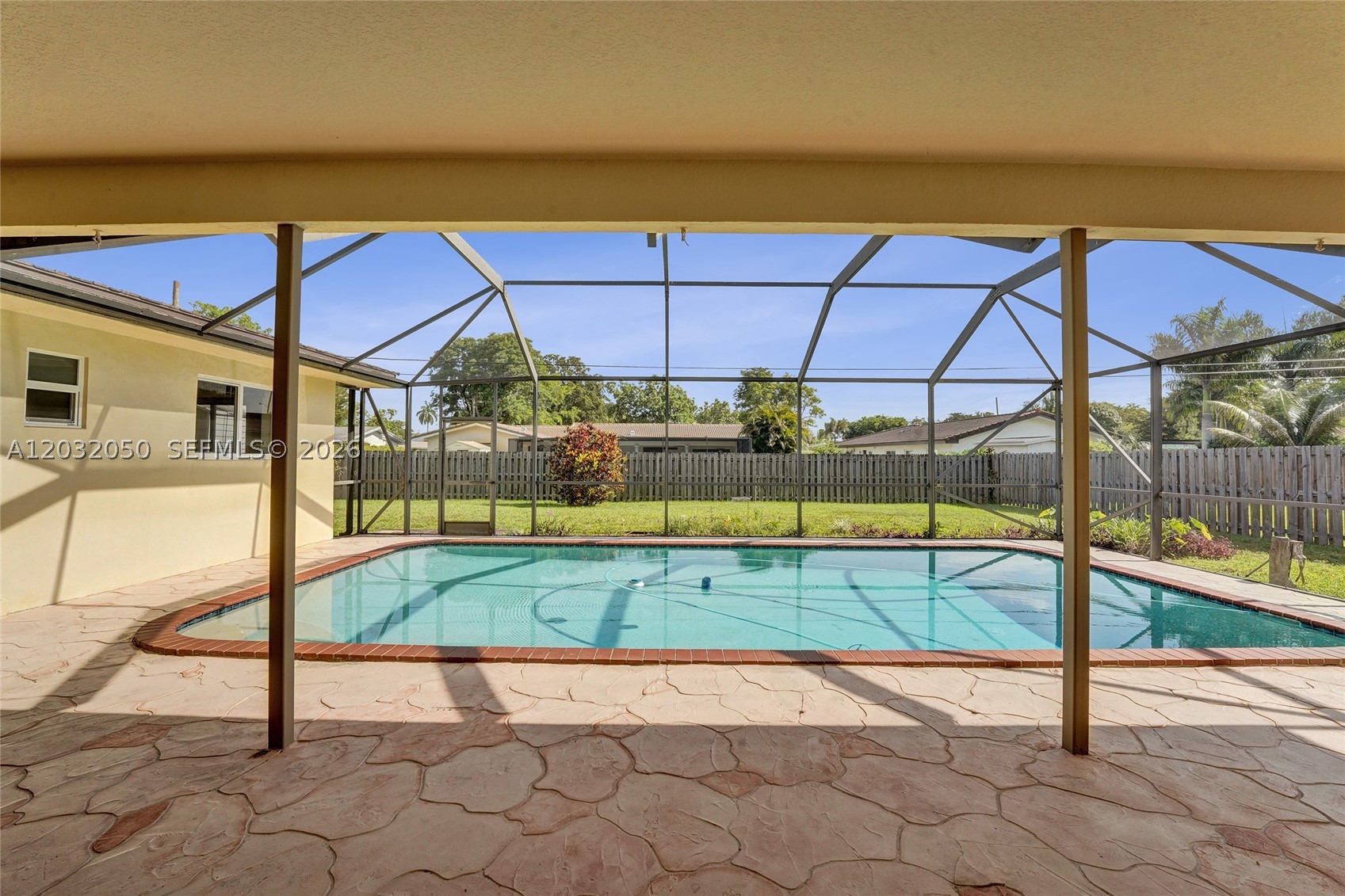 Rare opportunity to own this 4-bedroom, 2-bath pool home situated on a quiet street in the heart of Plantation with NO HOA! Featuring a desirable split-bedroom floor plan, this home offers spacious living areas designed for both everyday comfort and entertaining. Enjoy peace of mind with a metal roof and impact windows.  Step outside to your private South Florida oasis featuring a large, screened pool, covered patio, and expansive fenced backyard.  The oversized lot offers plenty of room for outdoor entertaining, pets, play areas, and even space for a boat or RV.    The convenient cabana baths provides direct pool access, while laminate flooring throughout the main living areas creates a warm and inviting atmosphere. Ideally located, this home offers the perfect combination of privacy, convenience, and lifestyle- near Liberty Tree Park, Central Park, Plantation City Hall, Police and Fire Departments and good schools.  Enjoy all the benefits of Plantation living with excellent access to I-595, Florida's Turnpike, downtown Fort Lauderdale, shopping, dining, parks, and the beaches. Don't miss a chance to own this Secluded Gardens Plantation home—no HOA restrictions, a private pool, impact protection, and an oversized lot.