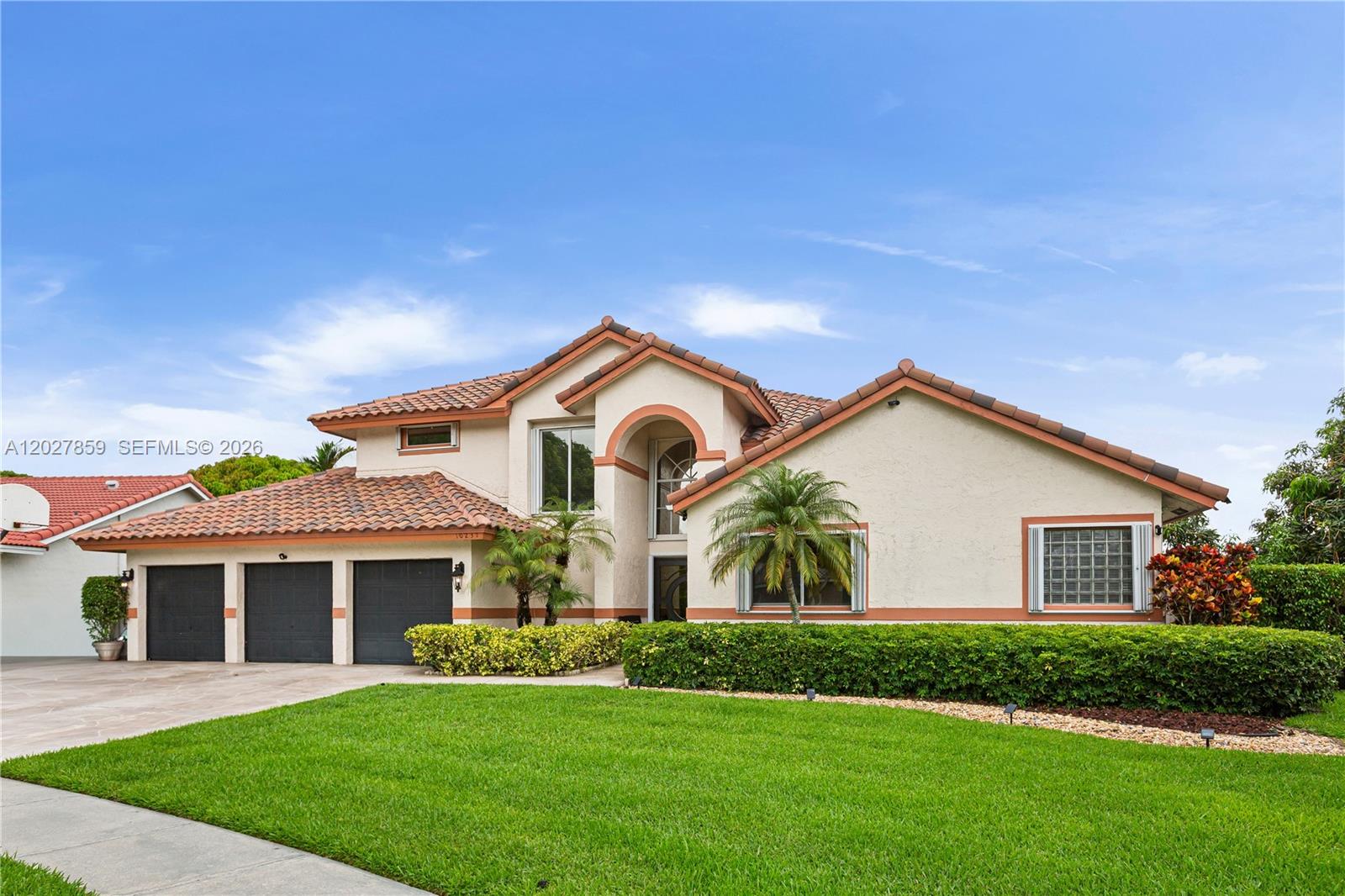 Welcome to The Landings, one of Pembroke Pines’ most desirable guard-gated communities, where beautifully maintained homes and mature landscaping come together w/ an exceptionally low association fee of only $100 per month. Proudly owned by the original owners since it was built in 1993, this impeccably maintained residence showcases the sought-after 3 car garage model and was thoughtfully designed with Elevation Option 2, offering a higher foundation elevation. This spacious home features a desirable layout with the primary suite conveniently located on the first floor, offering peaceful views of the pool and lake. A second bedroom and full bathroom are also located downstairs, creating flexibility for guests, family, or a home office. Designed for both comfort and entertaining, the screened pool enclosure, replaced approximately 3.5 years ago, allows for year-round enjoyment of the outdoor spaces while overlooking tranquil water views. The backyard feels like a private retreat with lush landscaping, a mango tree, seating areas, and a playground perfect for gathering and creating memories with family and friends. Plenty of green space allows everyone to enjoy the outdoors in comfort and privacy. Inside, the home has been beautifully updated with upgraded kitchen and bathrooms, newer A/C units, accordion shutters throughout, and a hurricane impact front door. The roof was replaced in 2023, reflecting the care and investment that has gone into preserving this exceptional home.