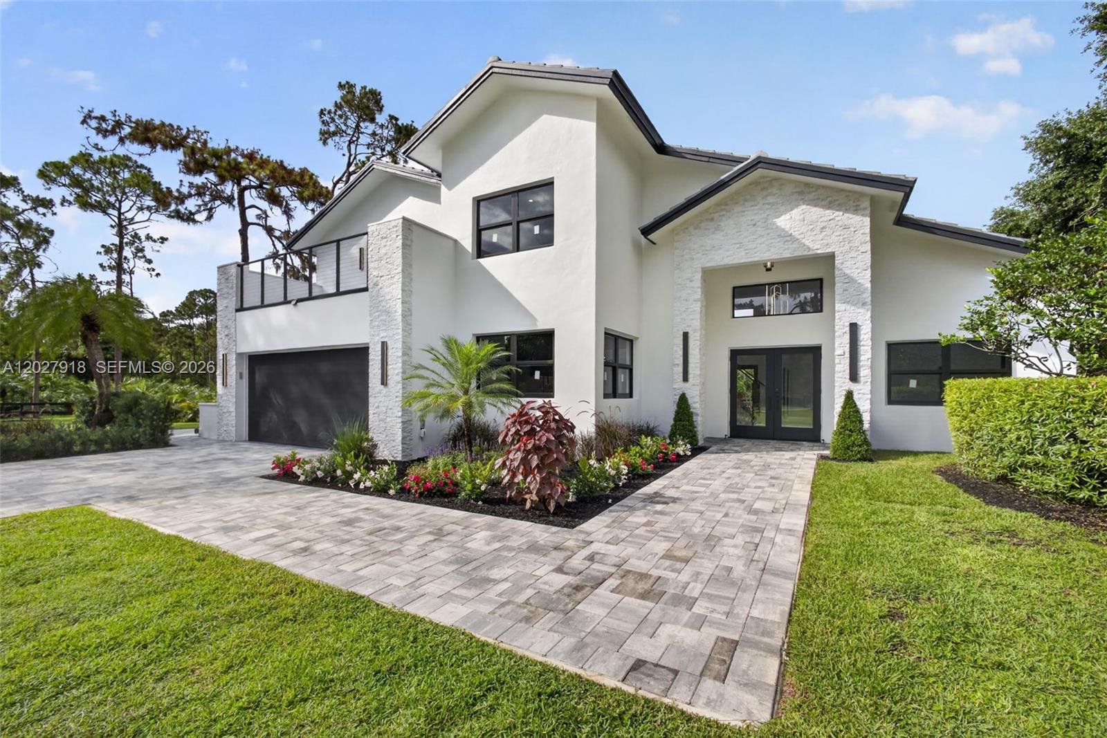 Step into a fully remodeled 5-bed, 4-bath equestrian estate on nearly 7 private, fully fenced acres. Reimagined with professional design, the residence features all-new systems: roof, impact windows and doors, updated plumbing and electrical, and whole-property irrigation. Inside, custom Lioher cabinetry is showcased throughout—including all closets. The chef’s kitchen centers on striking Cristallo countertops with generous prep and storage, flowing easily to the main living areas for everyday living and entertaining.

Spa-inspired bathrooms are newly finished with designer tile, frameless glass enclosures, sleek vanities with integrated storage, premium fixtures, and thoughtful lighting—delivering a fresh, modern look and low-maintenance durability.

Automatic gates open to expansive grounds with a new heated pool and a well-appointed outdoor kitchen, creating a seamless indoor-outdoor lifestyle. Purpose-built equestrian facilities include elegant stables with chandeliers, a tack room, feed room, bathroom, and an office/kitchen area—plus 12 full-size horse stalls and 13 mini-horse stalls. A state-of-the-art riding arena and multiple paddocks support training and turnout.

Thoughtful updates, durable finishes, and a practical layout deliver comfort, resilience, and ease of maintenance—combining privacy, amenities, and comprehensive equestrian infrastructure in one rare package.
