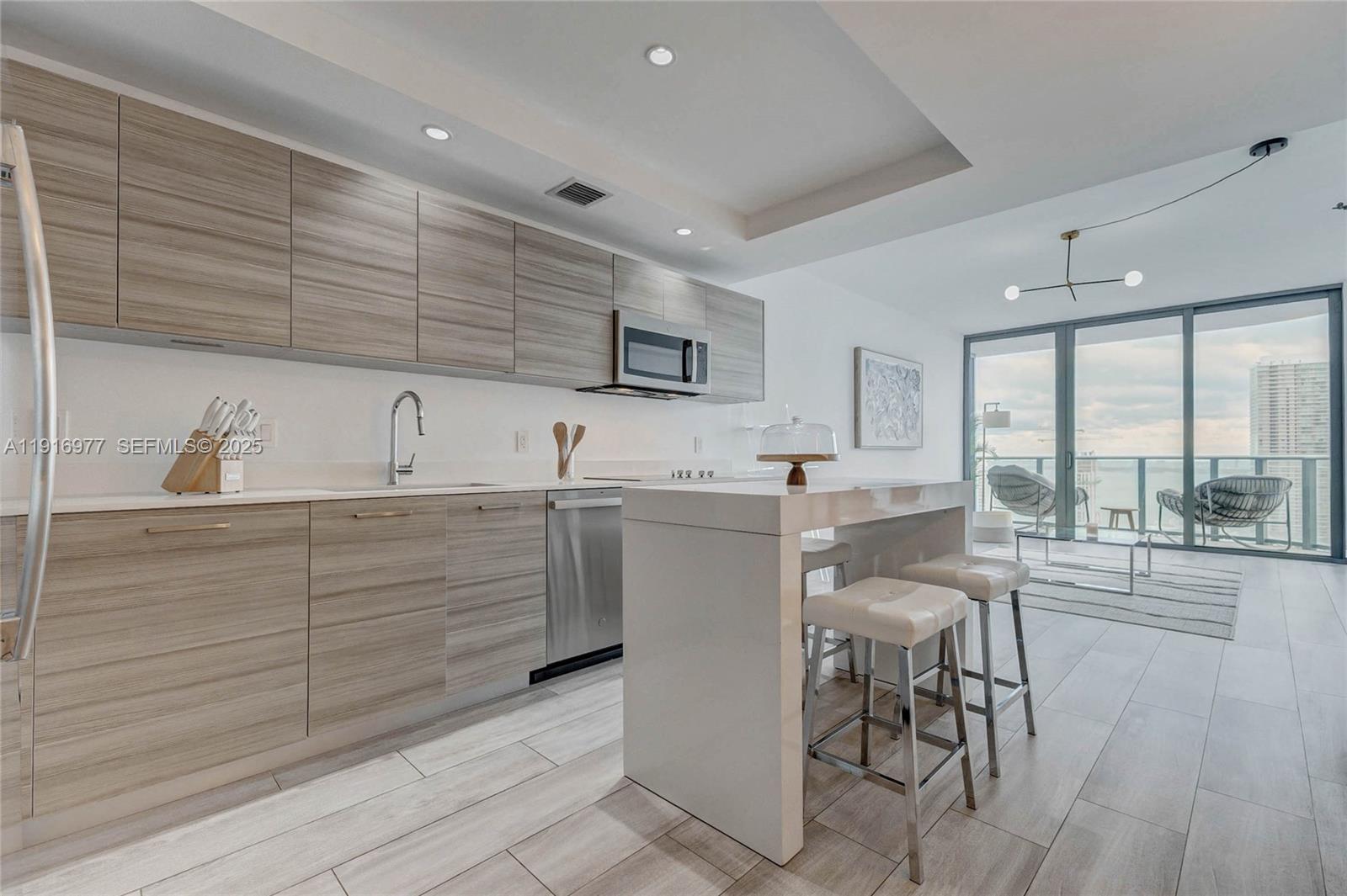 Experience modern living in this exclusive high-rise located in trendy Hyde Midtown Condo. This stunning unit offers unobstructed water views featuring 1 bedroom, spacious den/ office, and 2 baths. The interior boasts built-in closets and sleek modern fixtures. Water, basic cable and internet are included in the rent. Located in the middle of Midtown, and steps away from shops, restaurants, Miami Design District, Wynwood and Edgewater. Enjoy an array of amenities, including a doorman, valet parking, fitness center, tennis court, and putting green. Relax in the spa or in the common outdoor pool and jacuzzi. Entertain in the media/recreation and game rooms. The building also offers a billiards room and playroom. Easy to show. YEARLY LEASE ONLY.