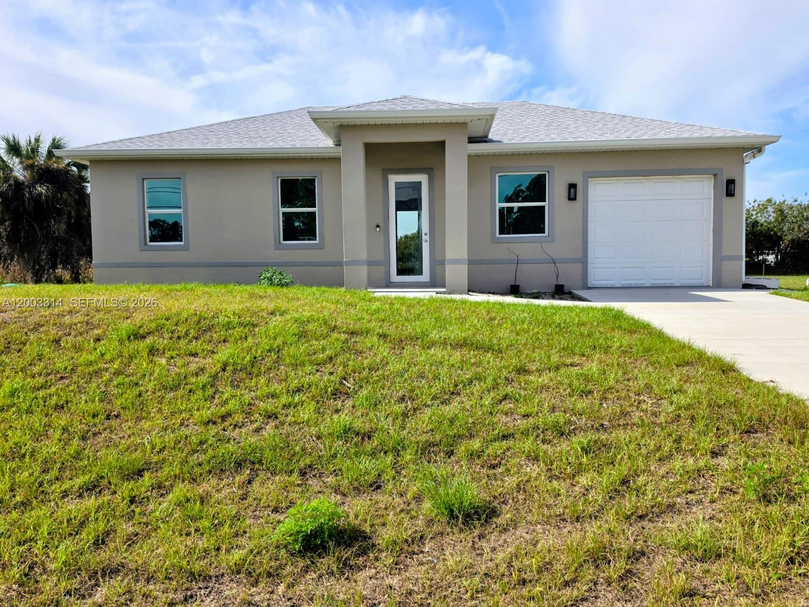 Seller is offering up to $10,000 toward buyer’s closing costs, subject to terms of the offer and lender approval. Brand-new 2025 construction offering modern design and functionality in a convenient Lehigh Acres location. This 3-bedroom, 3-bathroom home features an open-concept layout with a bright living area suitable for everyday living and entertaining. The kitchen includes quartz-style countertops, contemporary cabinetry, and stainless steel appliances. Additional features include impact-resistant windows and doors, upgraded lighting, and quality finishes throughout.

The property includes a third full bathroom located behind the garage, offering flexible use options for future configuration. Situated on a 0.23-acre lot, the outdoor space provides potential for future improvements such as a pool, patio, or garden.