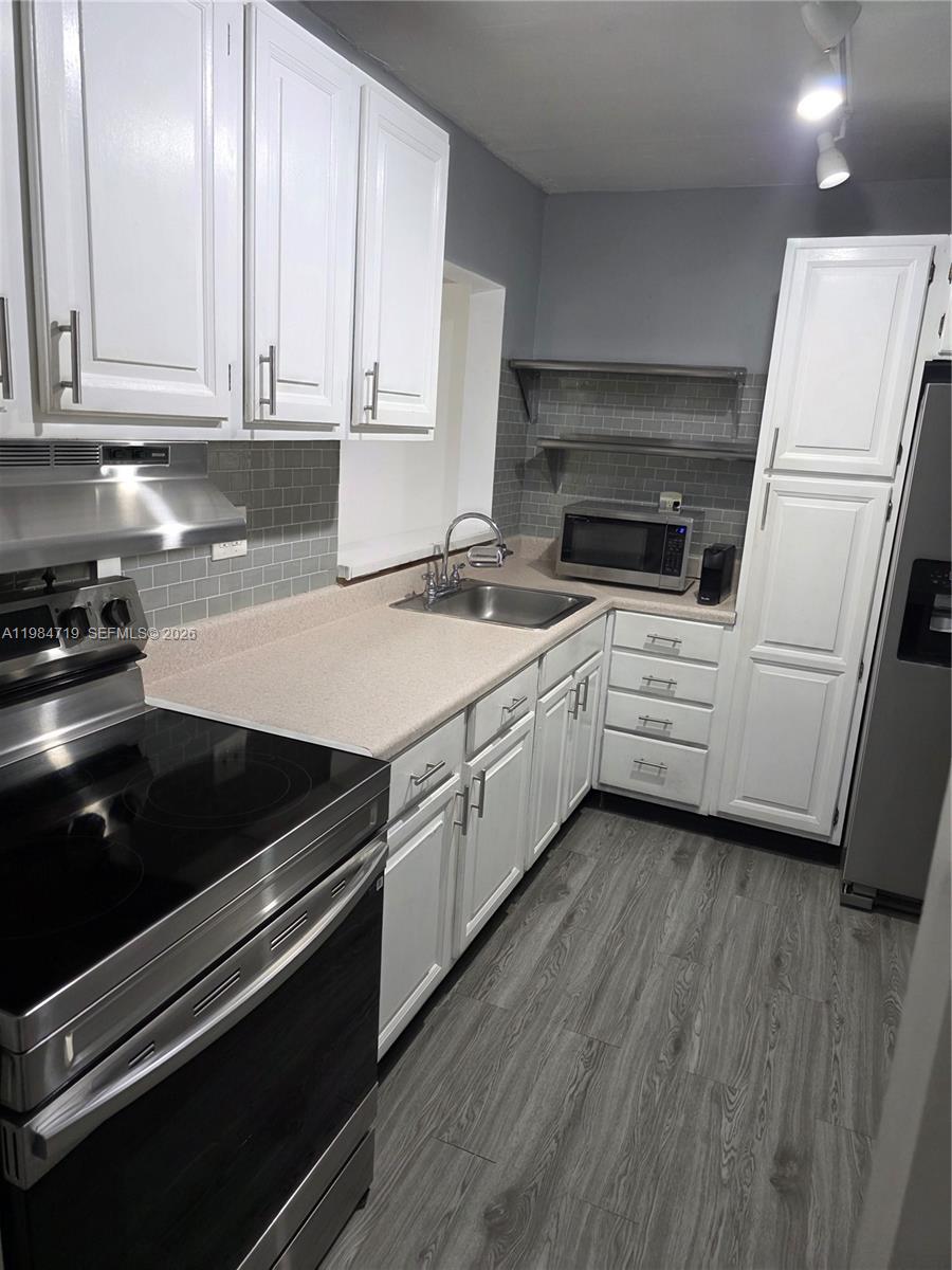 REDUCED TO SELL FAST! NOT CURRENTLY RENTED, OWNER OCCUPIED.  VERY SOUGHT AFTER HORIZONS (EAST) CONDO, 2 BEDROOMS, 2 BATHS, ON 2ND FLOOR, REMODELED KITCHEN WITH STAINLESS STEEL APPLIANCES (STOVE & HOOD REPLACED, REFRIGERATOR REPLACED 2 YRS AGO, MICROWAVE ALSO REPLACED) NEWER BLACKSPLASH AND CABINET HANDLES ALSO REPLACED, 2 DOOR REFRIGERATOR WITH WATER/ICE DISPENSER, STAINLESS STEEL SHELVES IN KITCHEN, EXTRA PANTRY CABINET FOR MORE STORAGE, UPDATED MASTER BATH WITH SHOWER, NEW WATERPROOF FLOORING INSTALLED IN L/R, D/R, KITCHEN , HALLWAY, AND FOYER. WATERPROOF VINYL FLOORING INSTALLED ON BALCONY, SCREEN BALCONY WITH STORAGE ROOM, REPLACED A/C CONDENSING UNIT ON ROOF IN 2021, HORIZONS OFFERS GREAT AMENITIES: (3) POOLS, (4) TENNIS COURTS, BEAUTIFUL CLUBHOUSE, GYM, 24 HOUR GUARD AT GATE PLUS ROVING GUARD IN EVENING HOURS, LOTS OF GUESTS PARKING , PLUS (1) ASSIGNED PARKING SPACE, LAUNDRYROOMS ON EACH FLOOR (3)WASHING MACHINES AND (3) DRYERS PER FLOOR, BEAUTIFUL PARK ACCROSS THE STREET FROM HORIZONS (INDIAN HAMMOCKS PARK), BUILDING HAS COMPLETED AND PASSED THEIR 40 YEAR CERTIFICSATION AND THERE ARE NO SPECIAL ASSESSMENTS.