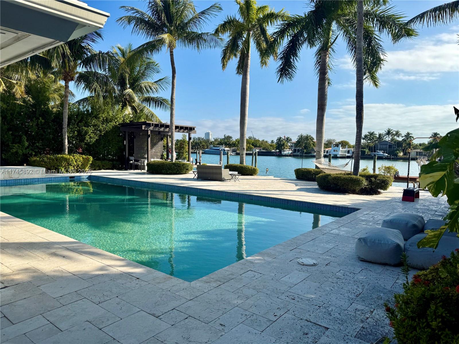 Don't miss this rare opportunity to own a prime open Bay views lot in Biscayne Point—an absolute paradise for boaters!

This expansive 11,250 SF lot boasts a beautifully remodeled 3,850 SF, 4-bedroom, 3.5-bath home, updated in 2010. The open-concept design features a gourmet kitchen with Subzero appliances, a dining area, a breakfast nook, and a spacious living room with stunning Bay views.

Move in as-is, customize the existing home, or build your dream waterfront estate. The outdoor space is perfect for enjoying Miami’s coastal lifestyle, complete with a large lap pool, gazebo, deep-water dock, boat lift, and no fixed bridges—ideal for yachts, speedboats, and jet skis.

Schedule your private showing today!