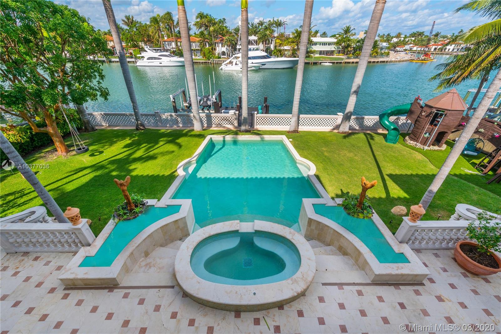Reminiscent of an opulent Italian villa, this magnificent Sunset Island estate affords space, privacy, and luxury on an expansive 20,000 SF lot overlooking sparkling Biscayne Bay. A private driveway, stunning lush landscaping and intricately thought-out, custom designed spaces lead to luxury living at its finest. This one-of-a-kind smart residence offers 8BR, 9+1BA & boasts 9,647 SF including a separate 2 bedroom,2 bathroom guest house. Offering 100 ft on deep water w/a dock and boatlift, the outdoors are an entertainers paradise w/a beautiful heated pool w/spa & expansive outdoor patio. Feat include:oversized gourmet kitchen w/top of the line appliances, fine Jerusalem stone floors, elegant crown molding throughout, Crestron controlled, custom built entertainment center and library/office