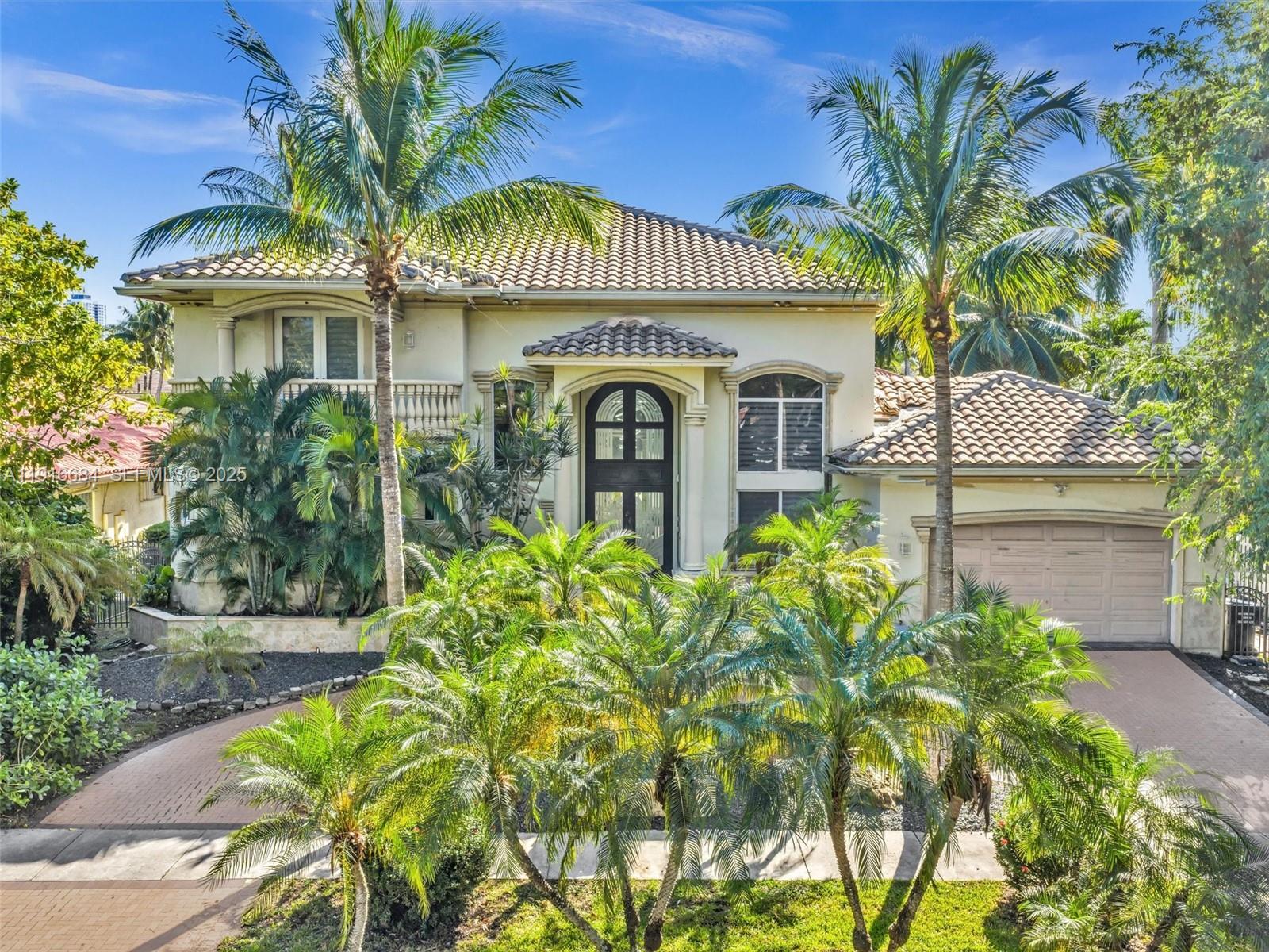 Elegant  5 BD /4.5 BA Mediterranean Villa, featuring a sophisticated triple-split floor plan, soaring ceilings, and marble floors through out. The refined Italian Kitchen includes premium high-end appliances. All bedrooms are on the main level, complemented  by entire- home surround sound and automatic Somfy shades. A fireplace with a custom mantle enhances the naturally lit living space, with an upstairs loft overlooking the great room ideal for a media lounge, gym or game room. Outdoors, enjoy a resort-style pool, a Covered outdoor bar complete with a spacious countertop - stool seating, an additional cabana bath and outdoor shower - an entertainer's dream for hosting, offering resort living at it's finest. Enjoying 86 ft of tranquil waterfront, and a private dock. This home is waiting for you- and your boat and jet skis - for true South Florida living. Exceptionally located close to pristine beaches, acclaimed dining, and major highways-this residence delivers timeless luxury and unmatched convenience.