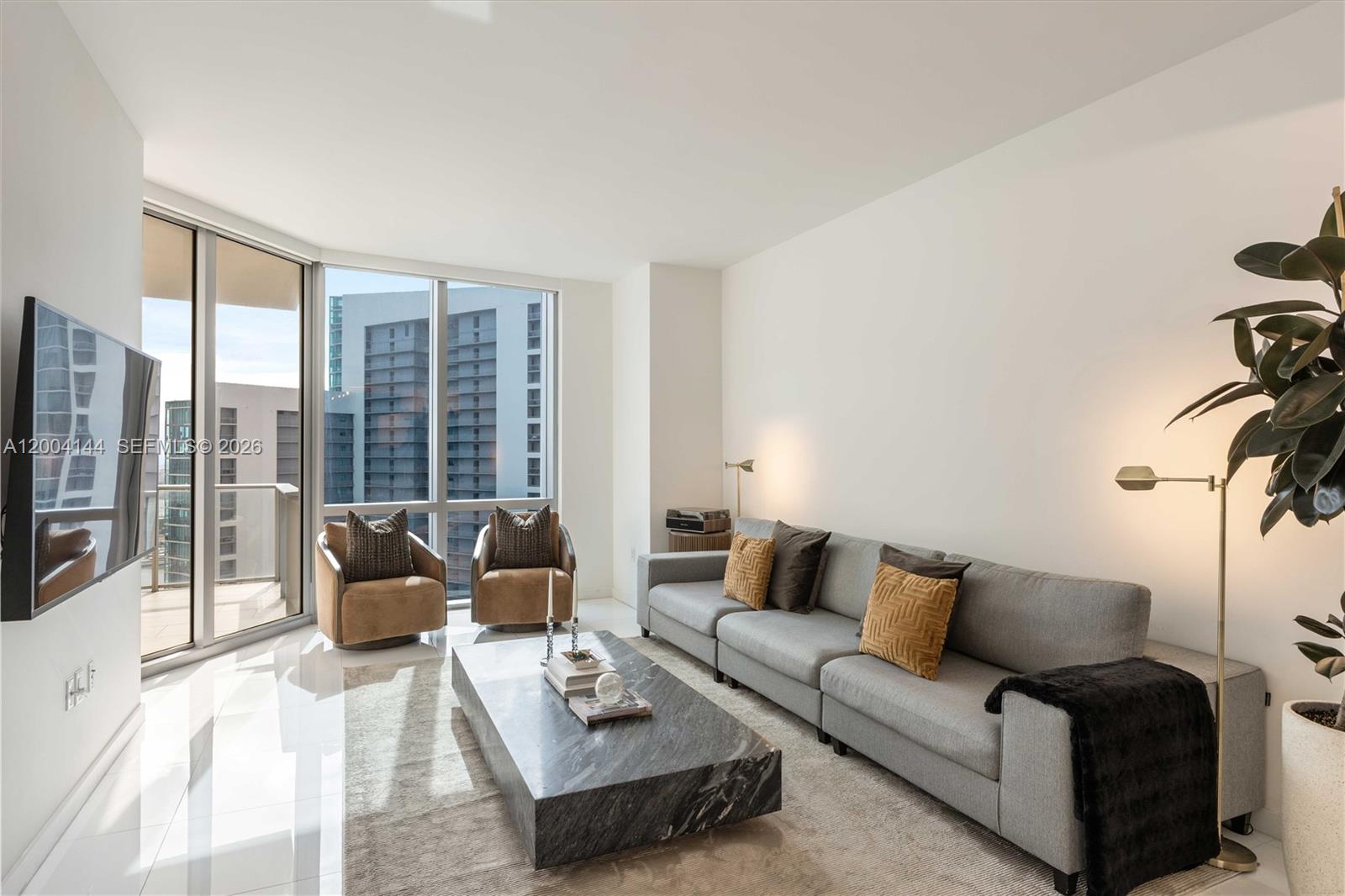 Perched on the 44th floor of Paramount Miami Worldcenter, this 1,254 SF residence offers one of the most desirable 1 bed +den floor plans in the building. Enjoy the ease of a private elevator leading directly up to your expansive foyer. The den, fully enclosed with a door, functions as a true second bedroom or private office — a rare find. Custom built-out closets, upgraded designer lighting throughout, and pristine move-in ready condition make this home truly turnkey.
Floor-to-ceiling glass frames unobstructed views of Downtown Miami and Biscayne Bay. High-end appliances, refined finishes, and a spa-inspired primary bath with a soaking tub complete the package. An oversized, deep balcony creates the perfect outdoor extension of your living space. Paramount Miami Worldcenter offers over 40 resort-style amenities — multiple pools, a full-service spa, fitness center, basketball court, yoga studio and more — steps from the city's best dining, shopping, entertainment, the Brightline train and the Kaseya Center.