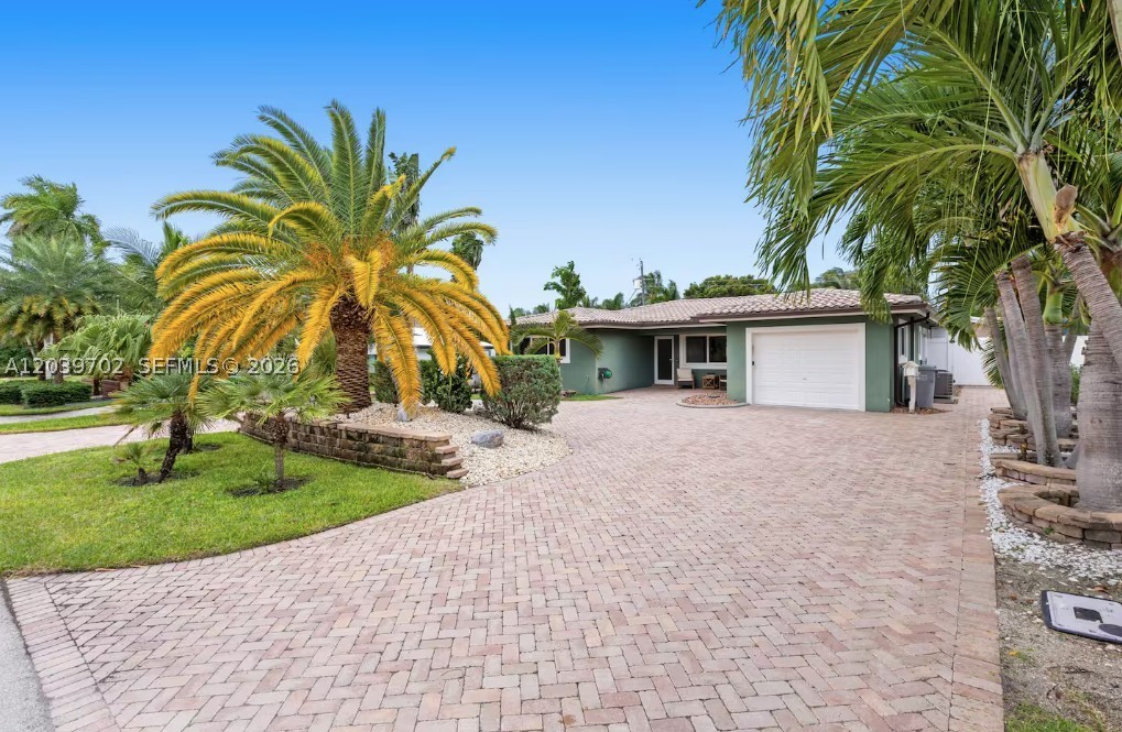 Discover this beautifully upgraded 3BR/2.5BA home in the desirable Pompano Beach Estates, just minutes from the beach, waterfront restaurants, shopping, golf courses, parks, and entertainment. This well-maintained residence features custom closets, laminate wood flooring, stainless steel appliances, granite countertops, impact windows and doors, a garage, laundry center, and updated PVC plumbing throughout.

Enjoy South Florida living at its best with a tropical backyard oasis featuring a circular paver driveway, fenced yard with artificial turf, and an impressive Tiki Hut complete with a granite bar, plumbing, electric, refrigerator, stove, and Alfresco grill. A premium landscape lighting system enhances the outdoor ambiance.

Located in a sought-after neighborhood known for its charm, convenience, and proximity to local attractions, this property is perfect as a primary residence, vacation home, or investment opportunity. With strong demand for short-term rentals in the area, it also offers excellent Airbnb income potential. Don't miss the chance to own a piece of paradise in one of Pompano Beach's most attractive locations.