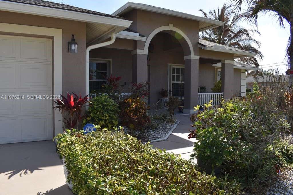 Checking many buyer boxes!  This 3/2, open-plan, single-story home with a 2-car garage is situated on a corner, well-fruited lot.  Even has recently installed solar panels (2022) and a new roof (2024), with a full set of accordion hurricane shutters.  When you enter the home from the covered patio, it opens wide to bedrooms on either side, a wide living area, a dining room, and a breakfast nook that overlooks the covered, screened patio, along with shutters to the garden. The primary suite has a tray ceiling, wooden floors, as do all bedrooms, plus walk-in closets, dual sinks in the primary bath. Includes a laundry room under air. You can tell that this original owner has cared for the home, just waiting for the next family to move right in!  Easy to show. Make an appointment today.