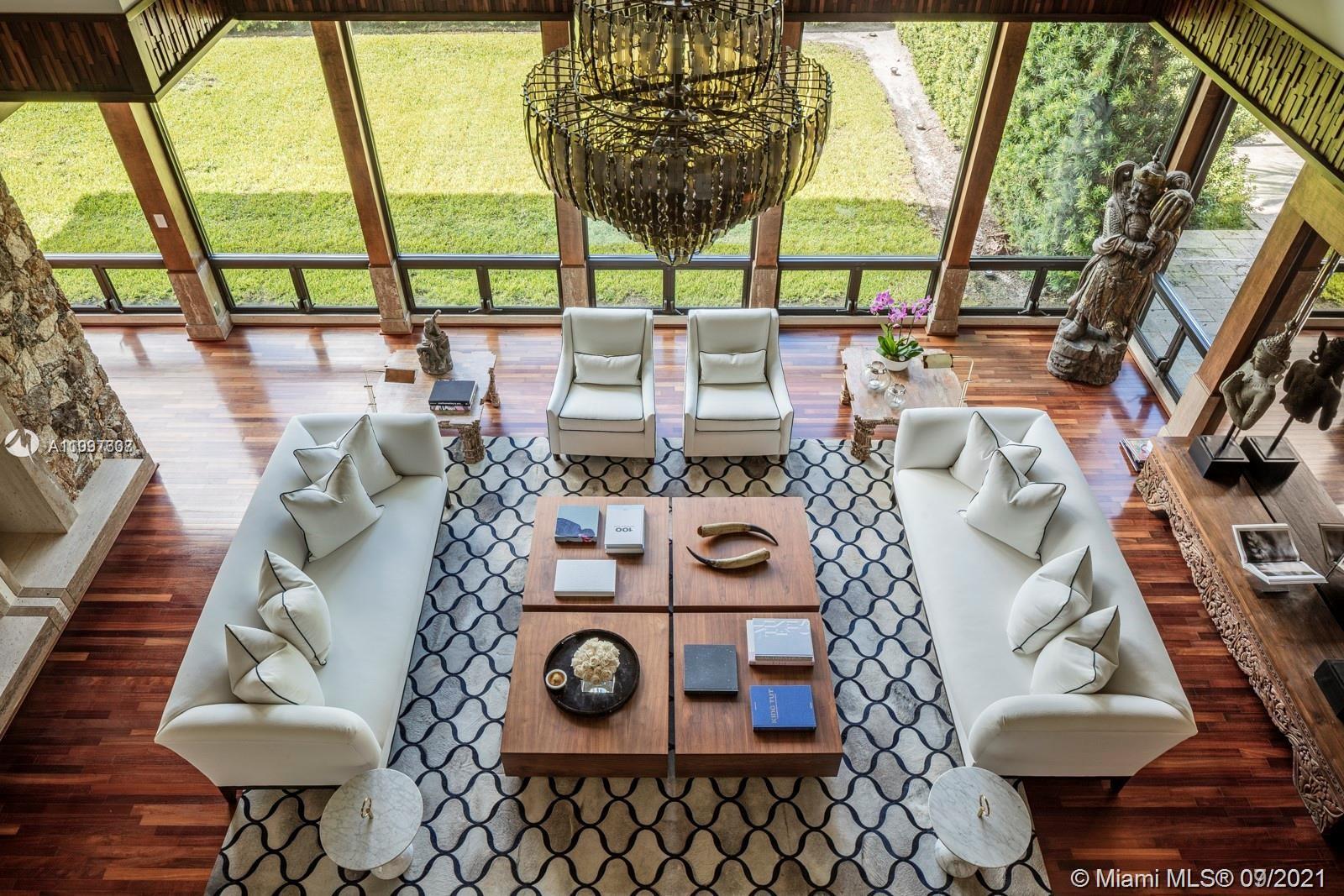Step Inside With Me! This truly unique residence is where Aspen meets Miami. Influenced by Frank Lloyd Wright, the design inspires nature's tranquility w indoor gardens, koi pond & a grand salon w 30' ceilings. Previously owned by a famous artist, this 6 Bed|9 Bath residence has been renovated & impeccably finished w no expense spared. The primary suite feats dual calacatta-clad baths,closets by Ornare,gym & spa w both sauna & steam rooms. Geared toward entertaining, the home feats a gorgeous chef's kitchen,climate-controlled wine cellar, fireplace & dual-sided bar for indoor & outdoor service alike,& a 10' deep pool. Sitting on 94' of water w direct access to open bay & situated in one of only a handful of truly private communities in all Miami, this property can be yours to call home