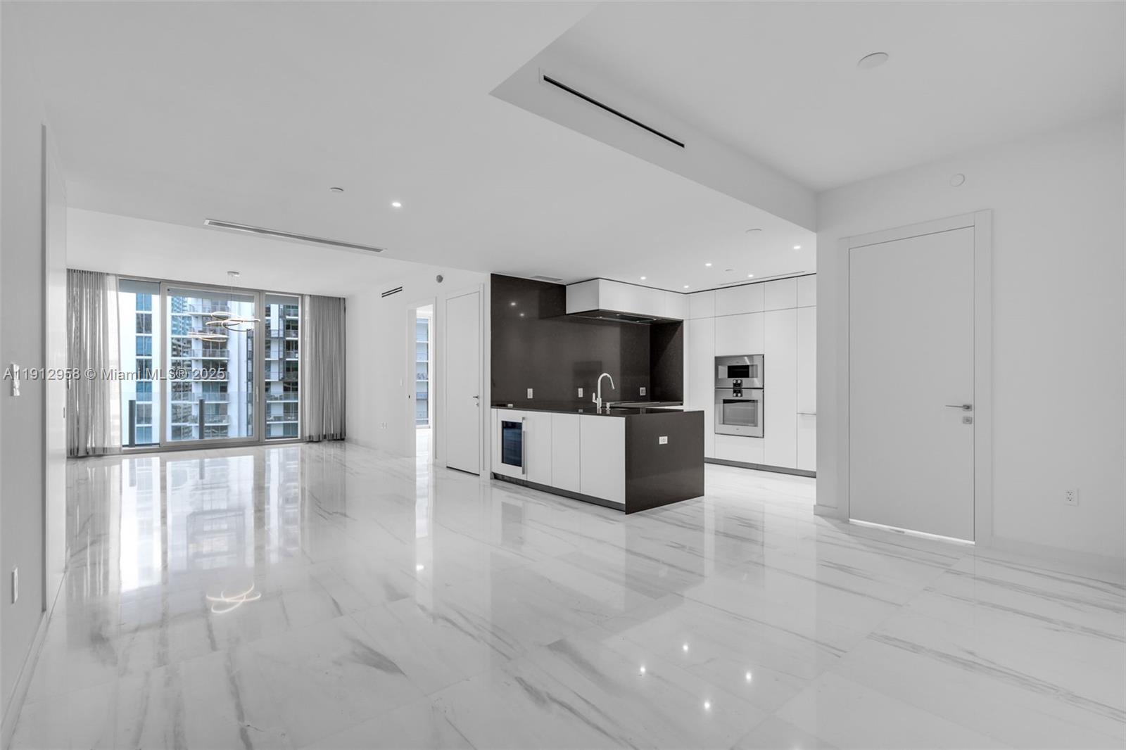 Experience elevated living at the iconic Aston Martin Residences.
This elegant 2-bedroom, 2.5-bath residence on the 30th floor offers open-concept living with floor-to-ceiling glass, porcelain marble-look flooring, and custom modern lighting. The gourmet kitchen features sleek European cabinetry, quartz countertops, and premium integrated appliances.

The primary suite includes a luxurious spa-inspired bathroom with a freestanding soaking tub, glass shower, dual vanities, and a spacious custom walk-in closet. Both bedrooms enjoy stunning city and partial water views through expansive windows.