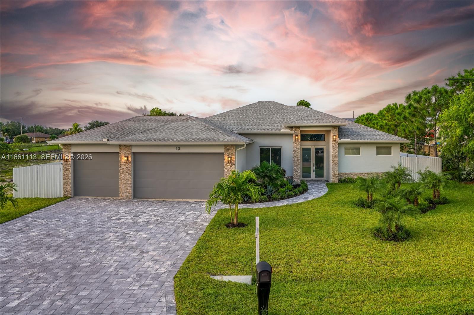 Introducing a stunning waterfront estate that epitomizes luxury living. This newly home features 4 spacious bedrooms and 3 elegant bathrooms, complemented by a three-car garage. Step outside to discover a breathtaking pool with a waterfall, a cozy firepit, and a built-in BBQ, perfect for outdoor gatherings.
Inside, the residence boasts a gourmet kitchen with sleek European-style cabinets, a stone wine rack, and pristine quartz countertops. The open-concept layout and soaring ceilings create a bright and inviting atmosphere, enhanced by sophisticated tile flooring. Hurricane-impact windows provide both security and peace of mind.
Enjoy the outdoor space with ceiling fans on the patio ensuring optimal airflow.