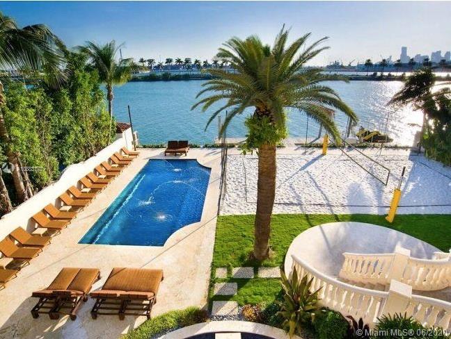 Located in the prestigious and gated Palm Island, this grand estate is a rare opportunity. The grand foyer welcomes you into the expansive living room w direct water views. Set on a 30,000 SqFt lot this 20,000 SqFt Estate includes 7 beds, 9 baths & 4 half baths. The sprawling Master Suite includes his & hers bathrooms, sitting area w fire place & a private balcony w stunning water views. A movie theater, chef's kitchen, two pools, volleyball court, 4 car garage & a private dock w 100 feet of frontage are just some of the features. Enjoy all of Palm Island's amenities including tennis & basketball courts, playground and 24 hour police security while also being minutes from the best shopping, restaurants & airports.