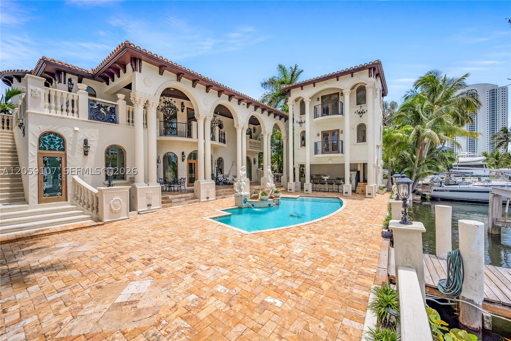 One-of-a-kind Mediterranean waterfront estate in the heart of Sunny Isles Beach. Custom built and expanded by its current owner—a Civil Engineer and one of the founding fathers of Sunny Isles Beach—this extraordinary residence offers timeless architecture, exceptional craftsmanship, and an unrivaled location. Situated on one of the area's largest waterfront parcels, enjoy boating from your private dock to your own private island or stroll to the neighborhood's exclusive beach access. Offering 8,460 SF under air, the estate features three independent residences with 9 bedrooms, 8 full baths, 2 half baths, 5 en-suite bedrooms, and 4 kitchens (3 indoor, 1 outdoor), making it ideal for multigenerational living, guests, or staff. The main residence includes 6 bedrooms, plus a 1BR/1BA guest house and a 2BR/2BA in-law suite with den. The property extends approximately 65 feet beyond the seawall, providing additional dockage. The main residence majority was rebuilt in 2009, retaining only a small portion of the original 1946 exterior walls. The poolside guest house was added in 2018, followed by the 2BR/2BA in-law suite in 2024. A rare opportunity to own one of Sunny Isles Beach's premier waterfront estates, combining privacy, flexibility, and resort-style living. Seller financing available for qualified buyers up to 30% of the purchase price.