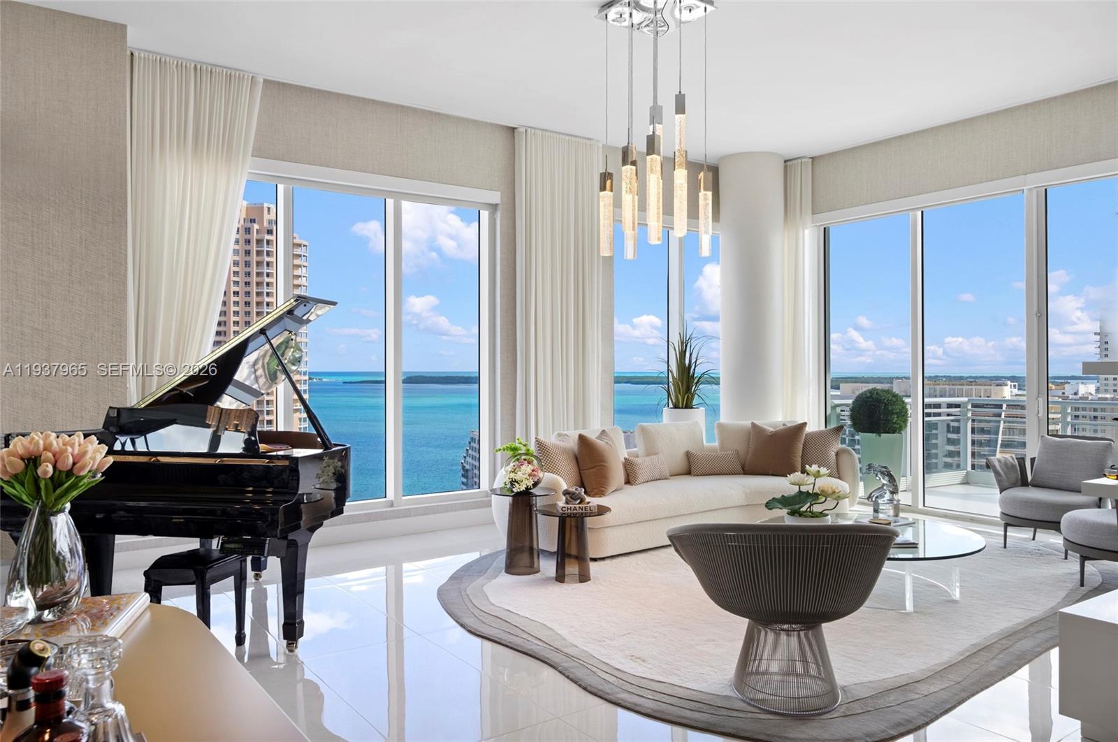 Discover refined Brickell Key living in this exceptional corner residence at Asia, one of the island’s most exclusive boutique buildings. This spectacular home offers breathtaking 180-degree panoramic views of the ocean, Biscayne Bay, and Miami’s iconic skyline.

A private elevator opens into a grand interior defined by soaring 12-foot ceilings, expansive glass walls, and marble surfaces paired with bespoke millwork—an elevated level of finish rarely found in condominium living. Timeless materials blend seamlessly with modern sophistication, creating an atmosphere of quiet luxury.

Four expansive terraces extend the living experience outdoors, offering stunning sunrise and sunset views with uninterrupted water and city vistas in every direction.

The gourmet kitchen features stone countertops, custom cabinetry, a wine cooler, built-in espresso machine, Miele ovens, Sub-Zero refrigerator, integrated microwave, and ceramic cooktop—ideal for entertaining and daily living.

The residence includes two assigned parking spaces and a private storage unit.

Resort-style amenities include 24/7 concierge and valet, tennis courts, swimming and resistance pools, Jacuzzi, state-of-the-art fitness center, and resident lounge.

A rare opportunity delivering prestige, privacy, and panoramic beauty at the highest level of Brickell Key living.