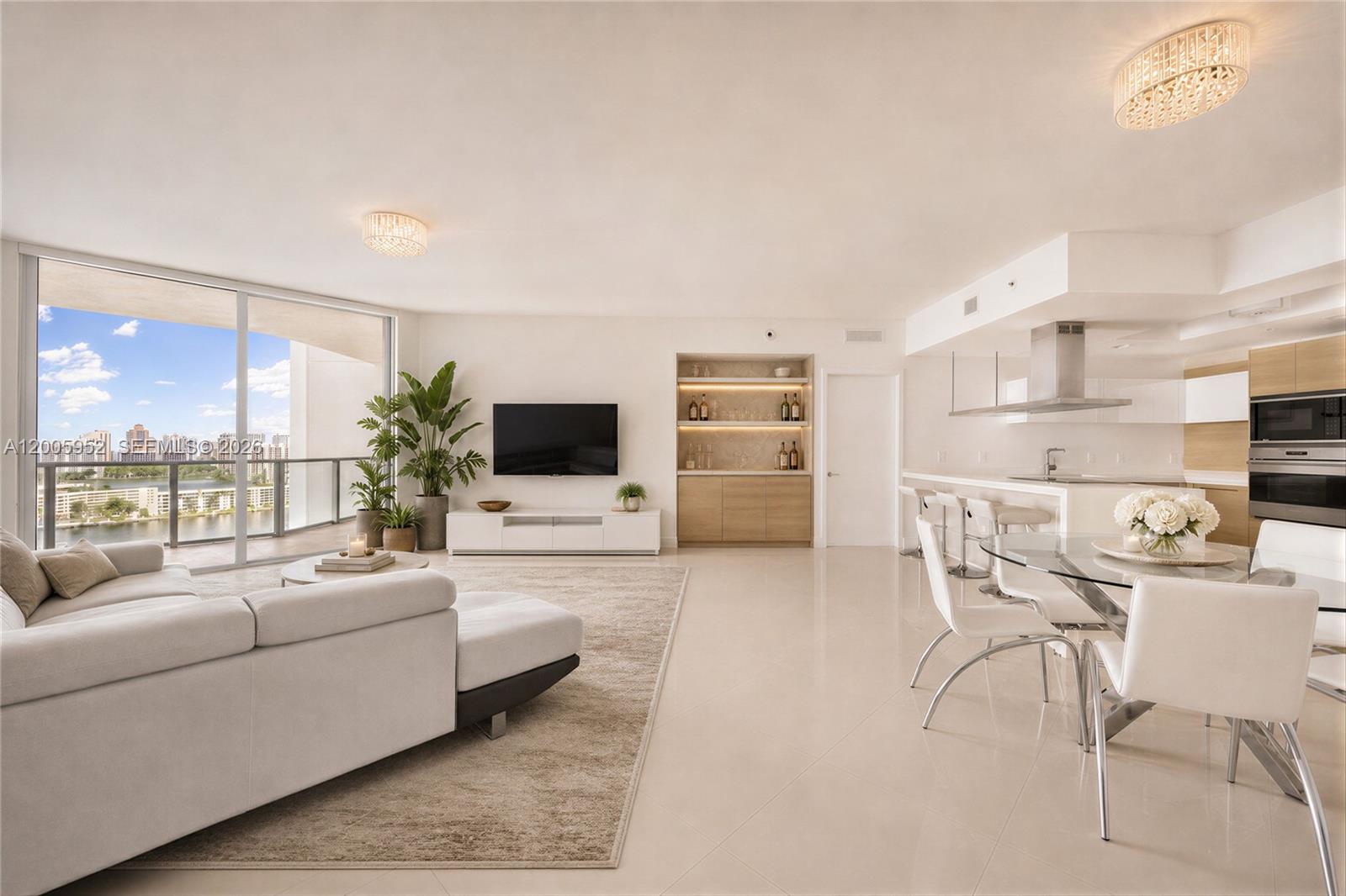 A refined waterfront residence at Marina Palms, offering elevated living with sweeping water views and direct access to a full-service marina and yacht club. Built in 2015 and impeccably maintained, this fully furnished 2-bedroom plus den showcases a desirable split floor plan, soaring ceilings, and expansive windows that fill the interiors with natural light. The versatile den offers flexibility for a third bedroom, office, or private retreat, while the primary suite is thoughtfully designed with a spacious walk-in closet and refined finishes. An open living and dining area extends seamlessly to a private balcony, creating an effortless indoor-outdoor flow. Residents enjoy a curated collection of resort-style amenities, including a state-of-the-art fitness center, Pilates studio, spa, sauna, and a waterfront pool with lounge areas. Additional offerings include a party room, children’s play spaces, concierge, valet, and top-tier security, delivering a lifestyle defined by comfort, convenience, and waterfront sophistication.