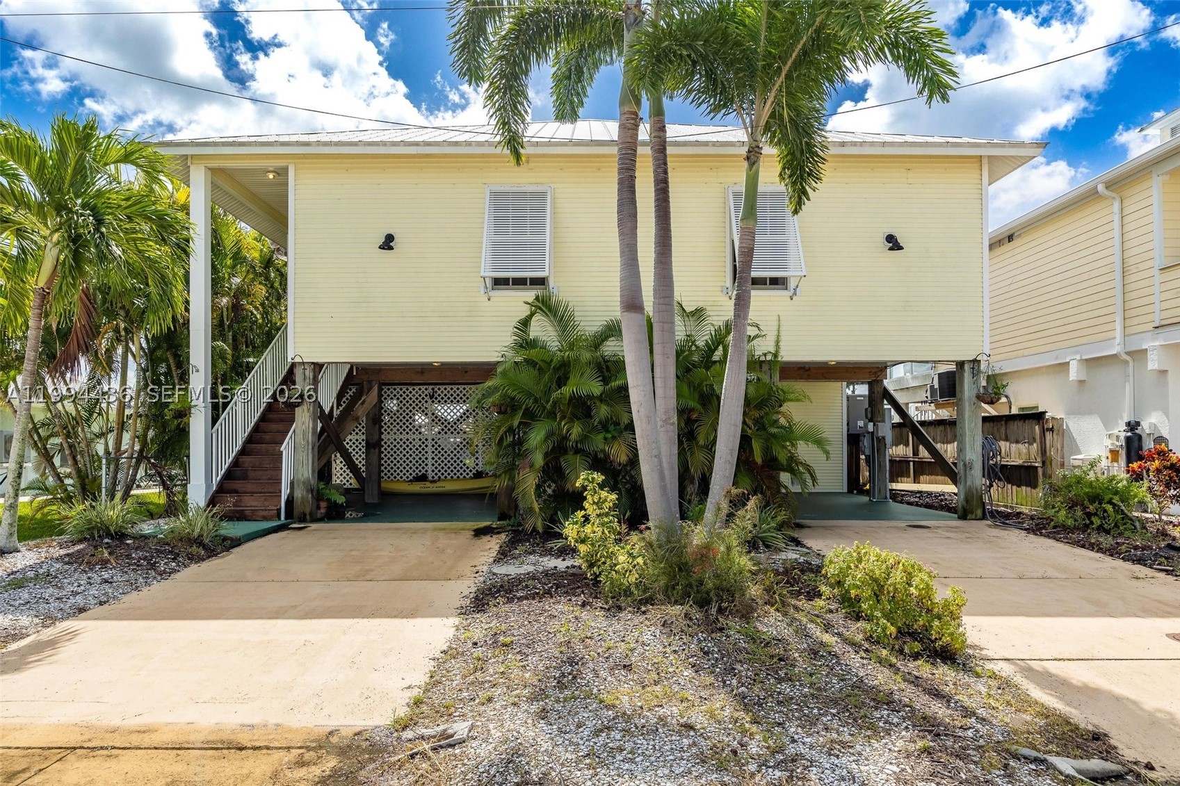 CALL MATLACHA HOME OR USE AS A VACATION RENTAL WITH NO WATER-INTRUSION WORRIES—CURRENTLY INCOME-PRODUCING This elevated 2-bedroom, 2-bath waterfront retreat offers island living at its best with hurricane-impact windows, an open kitchen-to-great-room layout, and stunning water views from nearly every room. Both bedrooms are spacious, and a flex space off the great room adds room for guests or a home office. Enjoy morning coffee and wildlife watching from the screened lanai, plus ground-level storage, a second patio, and a newer dock for boating. With minimal Ian damage and no known water intrusion, this is the best-priced elevated home in Matlacha and a move-in-ready paradise.