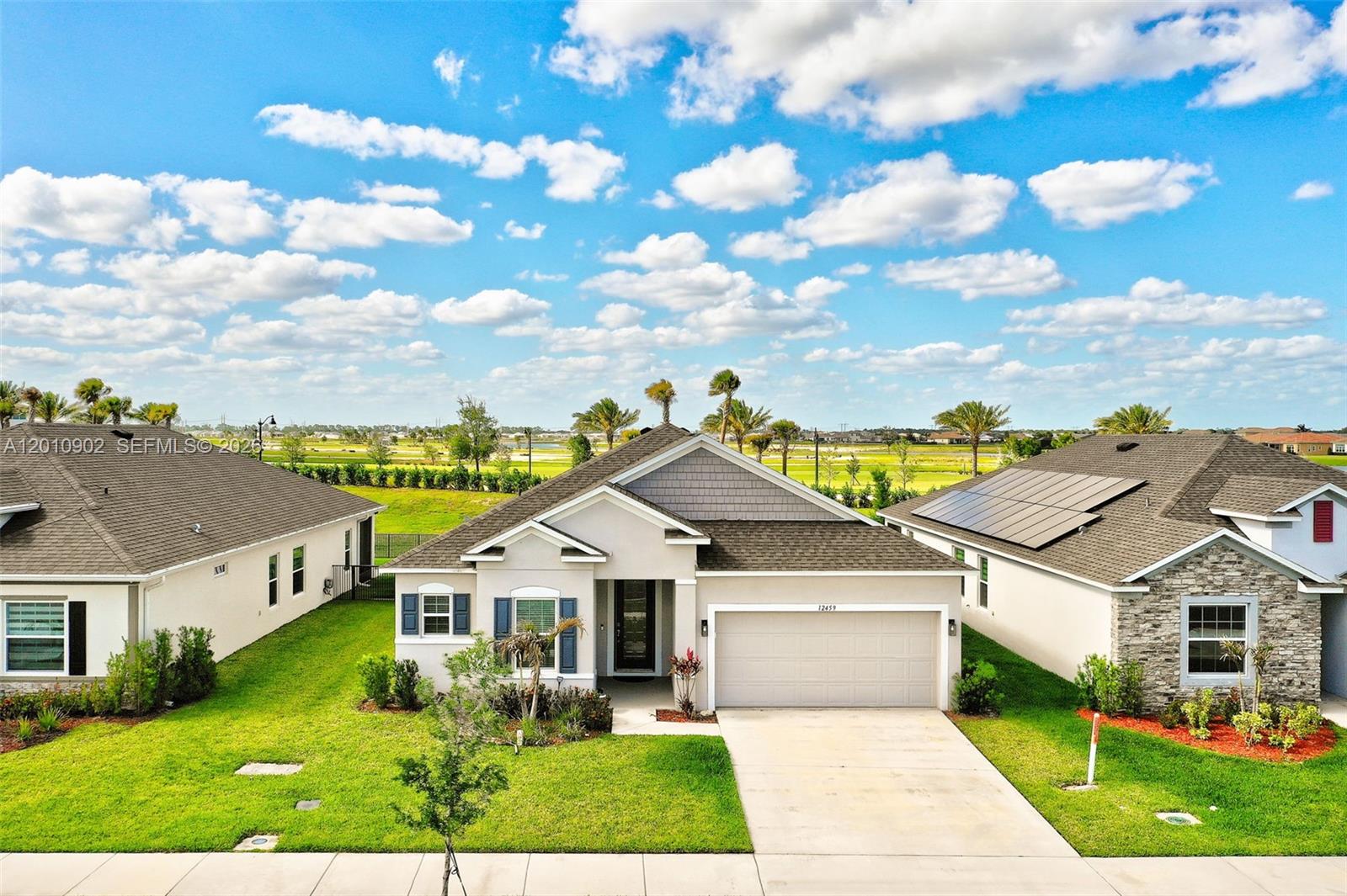 New construction home in Port St. Lucie offering the perfect blend of modern design, comfort, and privacy. This property features an open concept floor plan with high ceilings, abundant natural light, and a seamless flow ideal for today’s lifestyle. The upgraded kitchen is the heart of the home, complete with granite countertops, stainless steel appliances, a large island with seating, and ample storage perfect for entertaining or everyday living. The spacious primary suite provides a relaxing retreat with tray ceilings, a walk in closet, and a spa inspired bathroom with dual vanities and a glass enclosed shower. Enjoy indoor outdoor living with sliding glass doors leading to a covered patio and a private backyard with no rear neighbors. Additional highlights include tile flooring in main living areas, a versatile flex room ideal for a home office or gym, and a 2 car garage. Located in a growing Port St. Lucie community near top rated schools, shopping, dining, and major highways, this home is ideal for families, first time buyers, or investors seeking value, location, and long term potential.