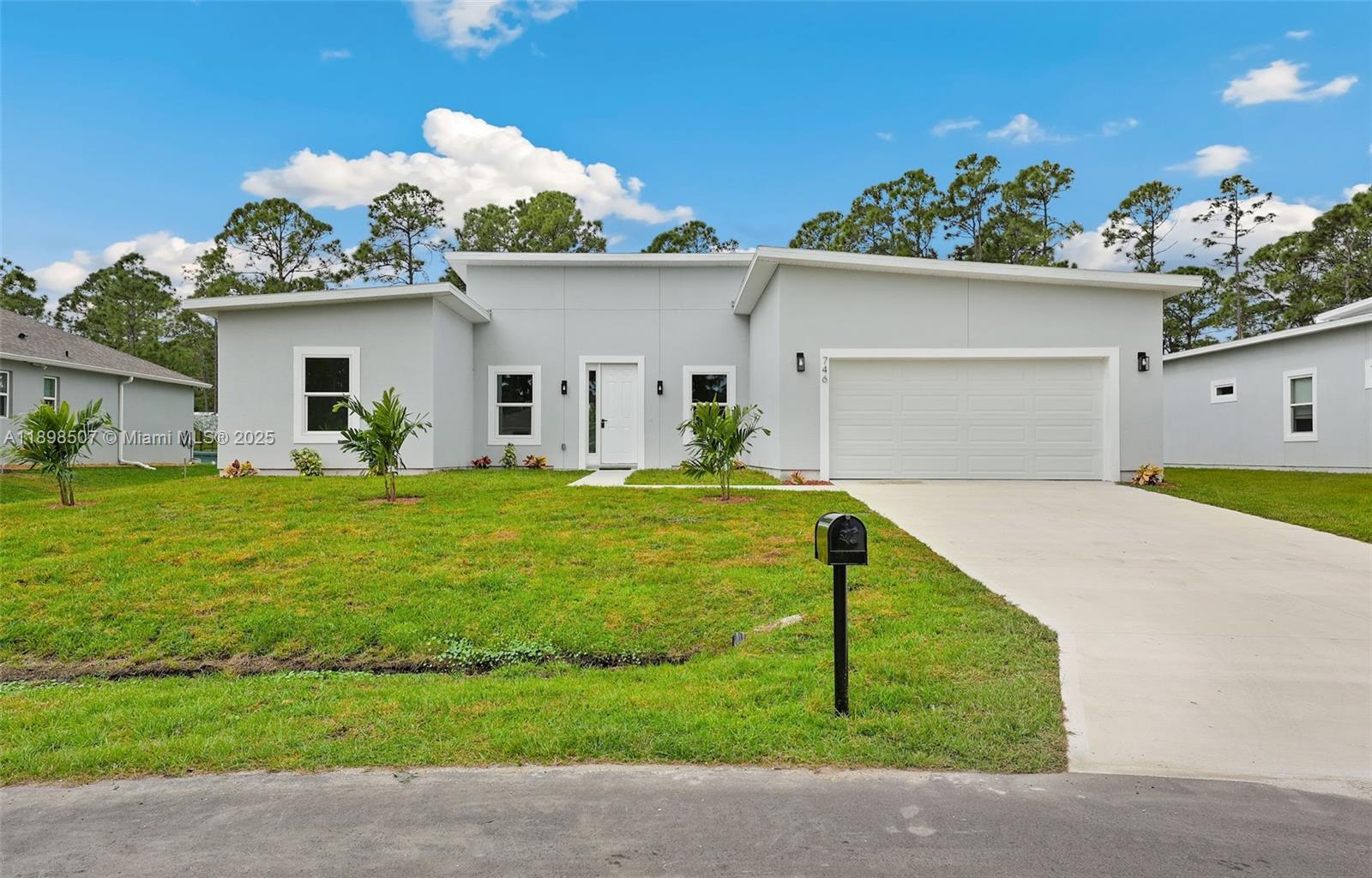 Step into this beautiful and modern home with high ceilings, offering 4 spacious bedrooms and 3 full bathrooms. The open floor plan features a great room perfect for relaxation and gatherings. The beautifully designed kitchen boasts quartz countertops, an island, and stainless steel appliances. The master suite offers a large walk-in closet and a master bathroom with white quartz double sinks and a wall-to-ceiling tiled shower, combining style and luxury. Enjoy peace of mind with impact windows, ensuring safety and tranquility.