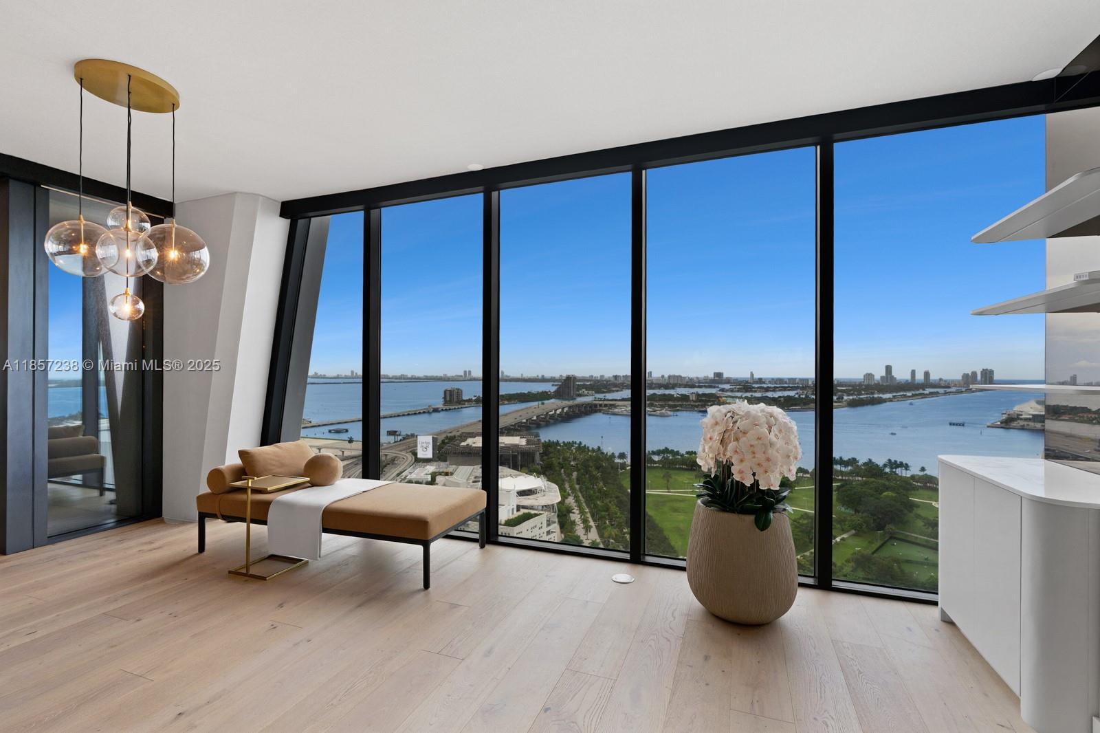 Stunning residence in The One Thousand  Unit 2402 offers breathtaking panoramic views of the ocean and city skyline. Featuring floor-to-ceiling windows, an open-concept layout, designer finishes, and a gourmet kitchen with high-end appliances. Expansive private terrace perfect for indoor-outdoor living. Enjoy 5-star amenities: 24/7 concierge, infinity pool, luxury spa, fitness center, and valet. A rare opportunity to own in one of Miami’s most iconic luxury towers